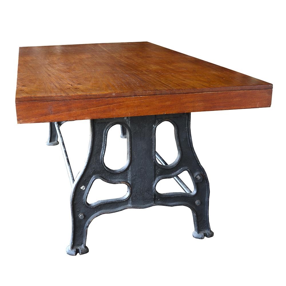 The fir top upon these antique cast iron machine legs makes for a lovely contrast of warm natural and industrial metal materials. The machine base is a great example of an early 20th-century industrial aesthetic with curvilinear lines designed to
