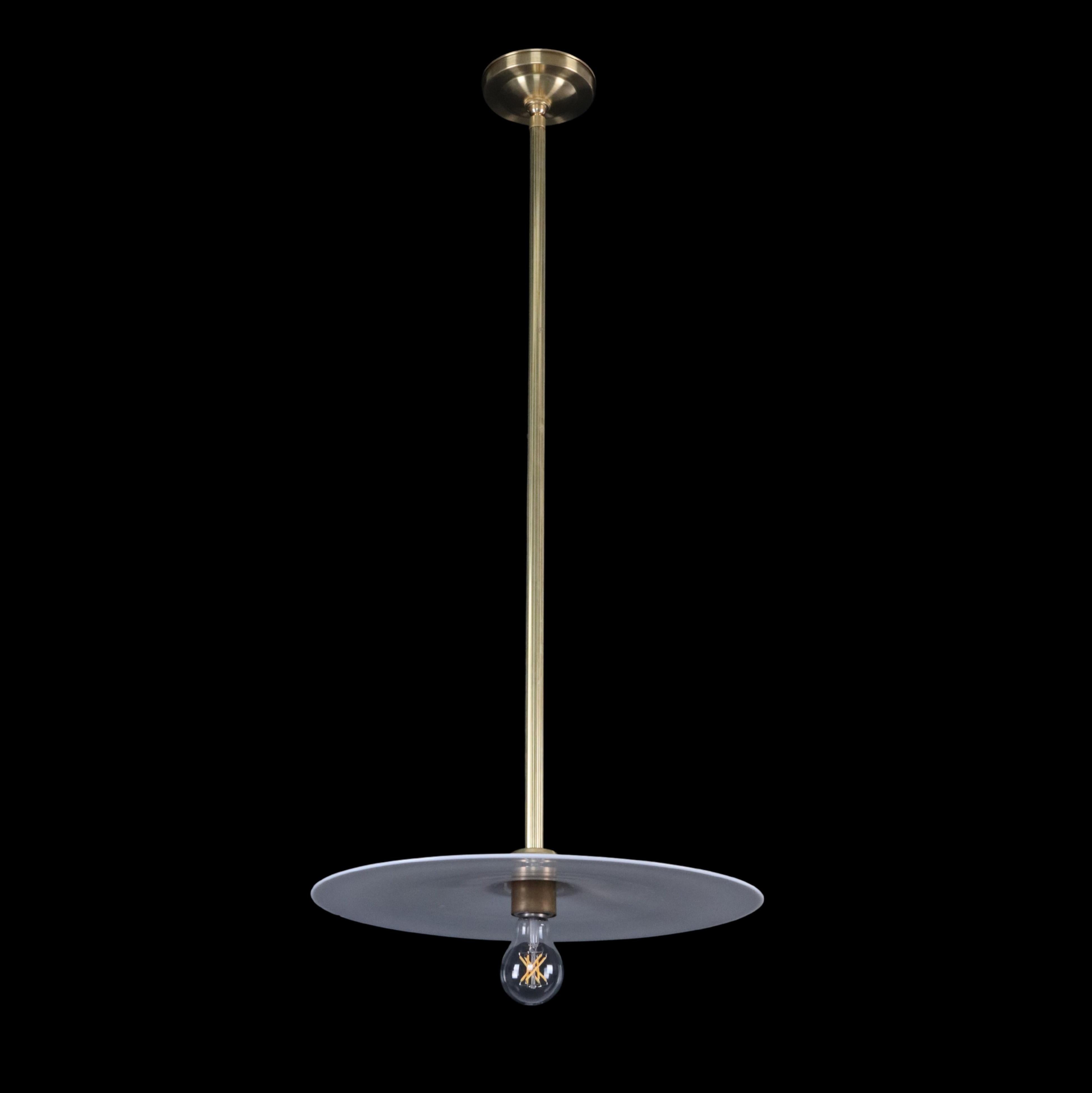 Industrial style pendant light with a circular white flat disc shade, a polished brass rod, and an exposed bulb. This light requires one Edison style medium base light bulb. Cleaned and restored. This light is cleaned, wired, and ready to ship. One