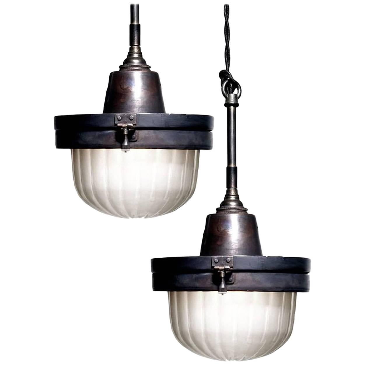 This is an interesting and very unique looking lamp. The fixture itself has a hinged copper body with locking hardware. The glass is a nice frosted and ribbed glass dome. Our design inspiration came from early railroad car ceiling flushmounts. I