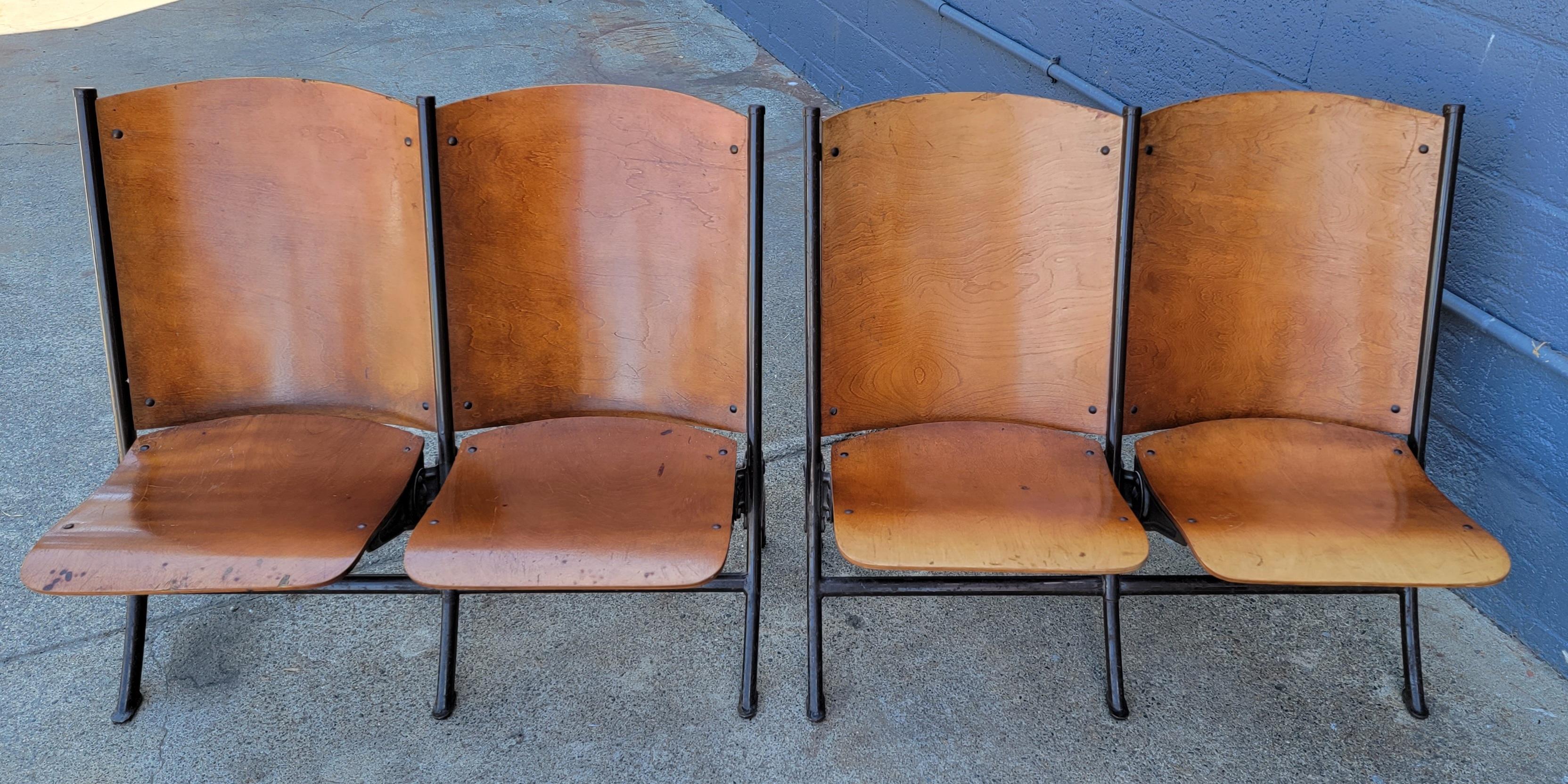 Rustic, industrial pair of 2 seat folding auditorium or theater chairs. Steamed plywood seats and backs mounted to painted steel frames. In original, unaltered condition. Wonderful patina from use and history. I was informed by previous owner that