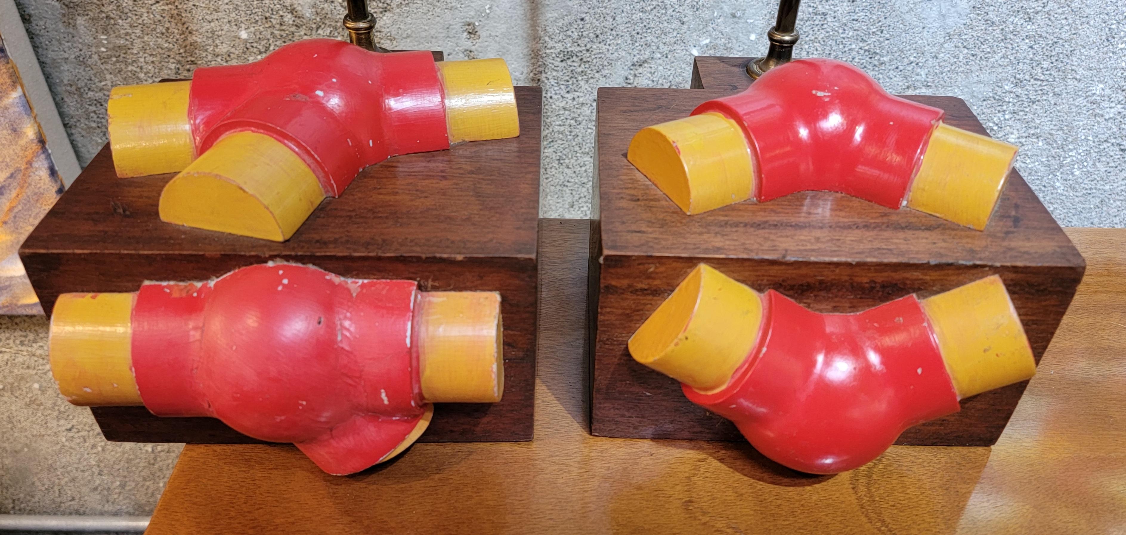 A pair of assembled table lamps incorporating vintage foundry molds mounted to a solid block of walnut. Vintage 60's brass sockets, harps and shade post. Offered without shades.