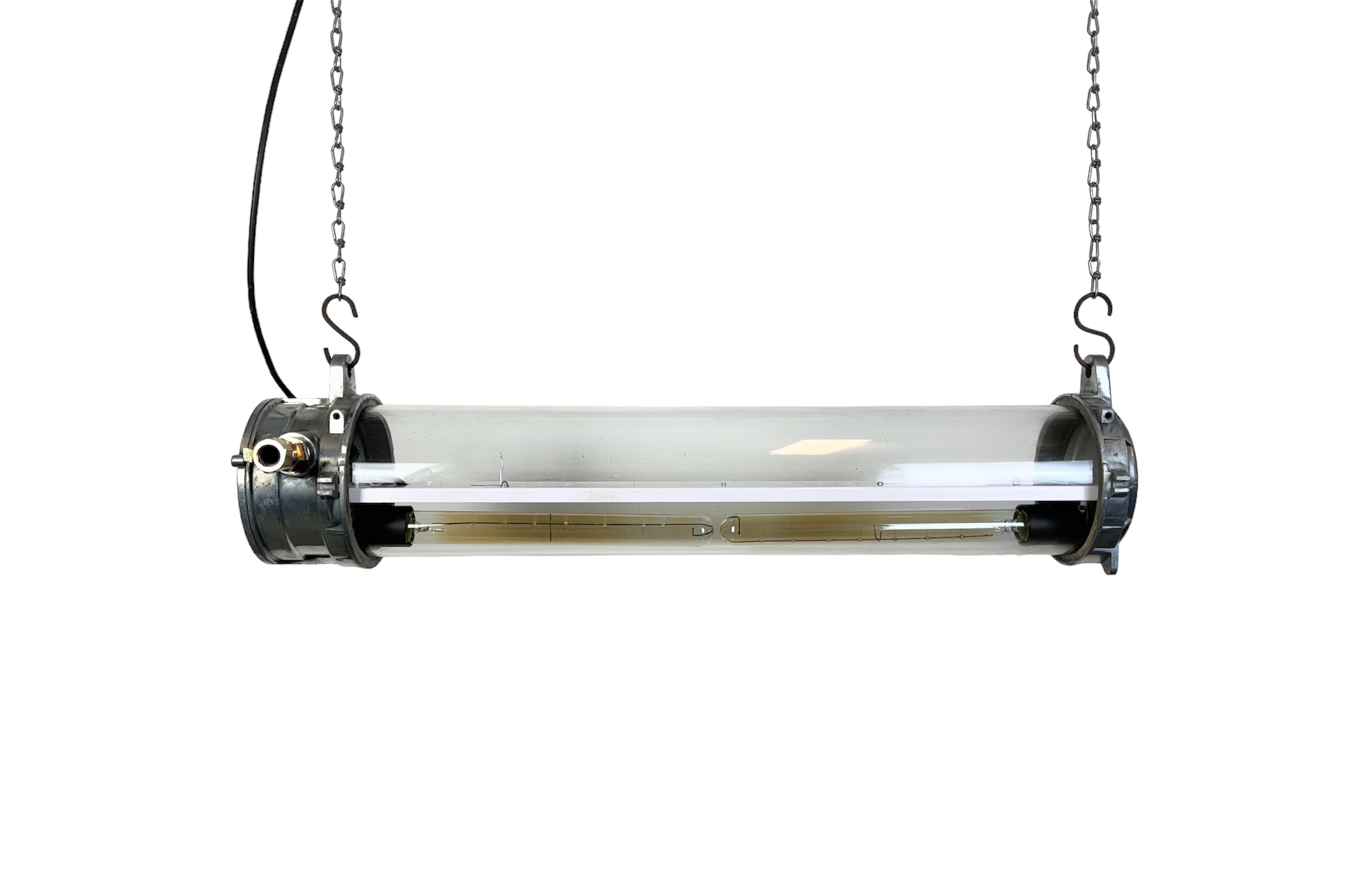 This industrial tube light was made by A.T.X Amiens-France during the 1970s. It is made of an aluminium and a glass tube. The light requires two E27/ E26 light bulbs. The weight of the lamp is 7,6 kg. Two Edison light bulbs are supplied with the