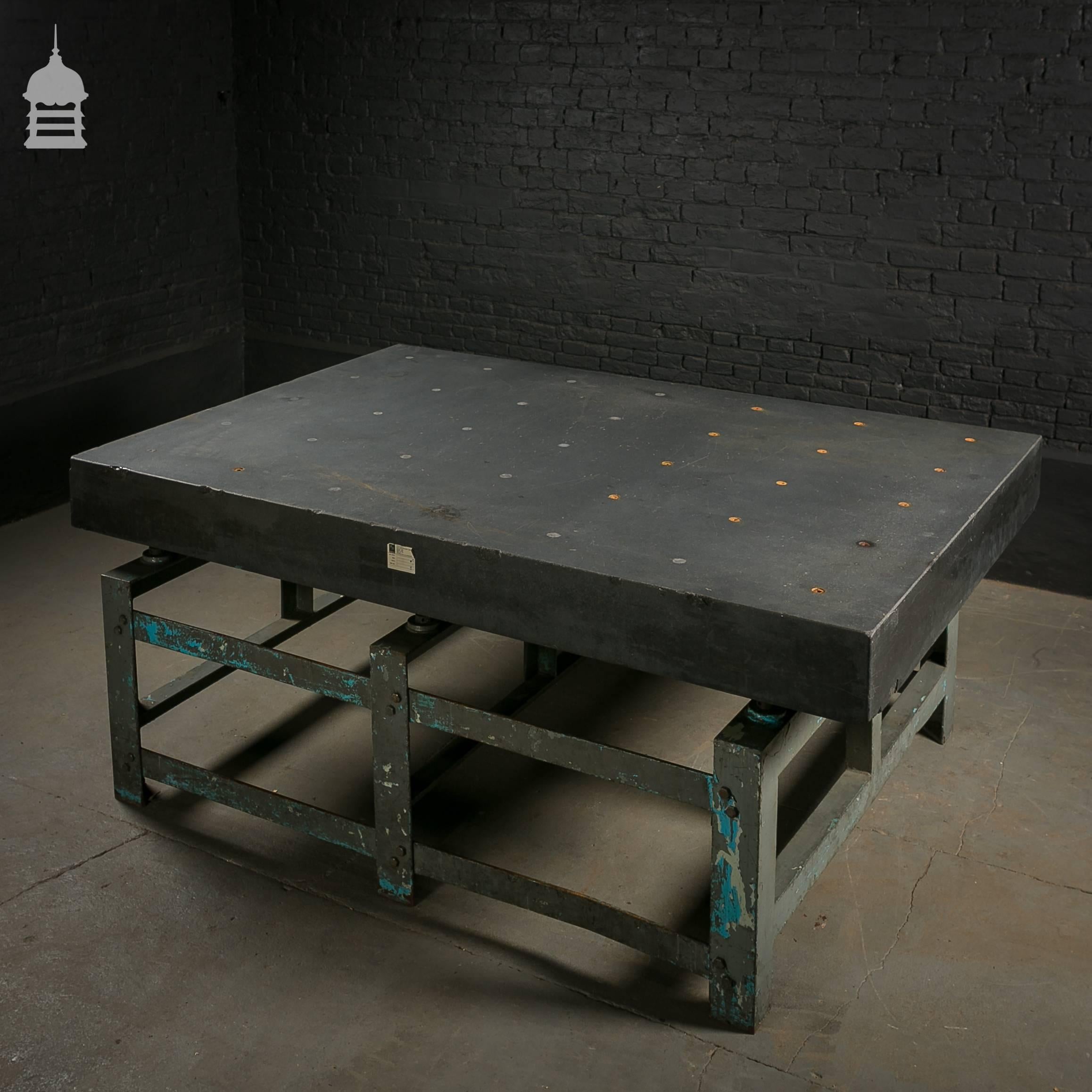 Industrial granite topped machine table with steel base.