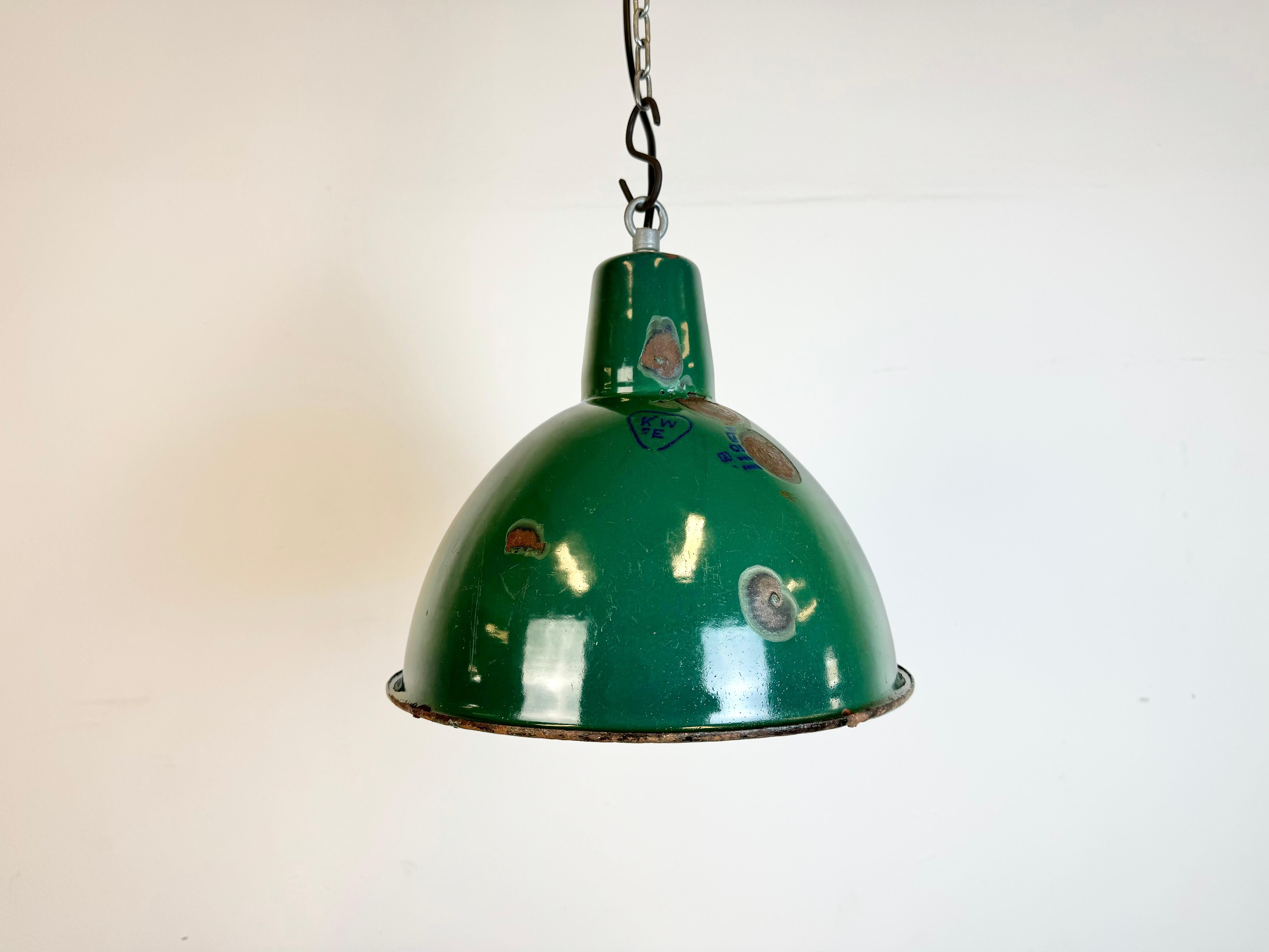 Industrial green enamel pendant light made by A23 factory in Wilkasy in Poland during the 1960s. White enamel inside the shade. Iron top. The porcelain socket requires standard E 27/ E26 light bulbs. New wire. Fully functional. The weight of the