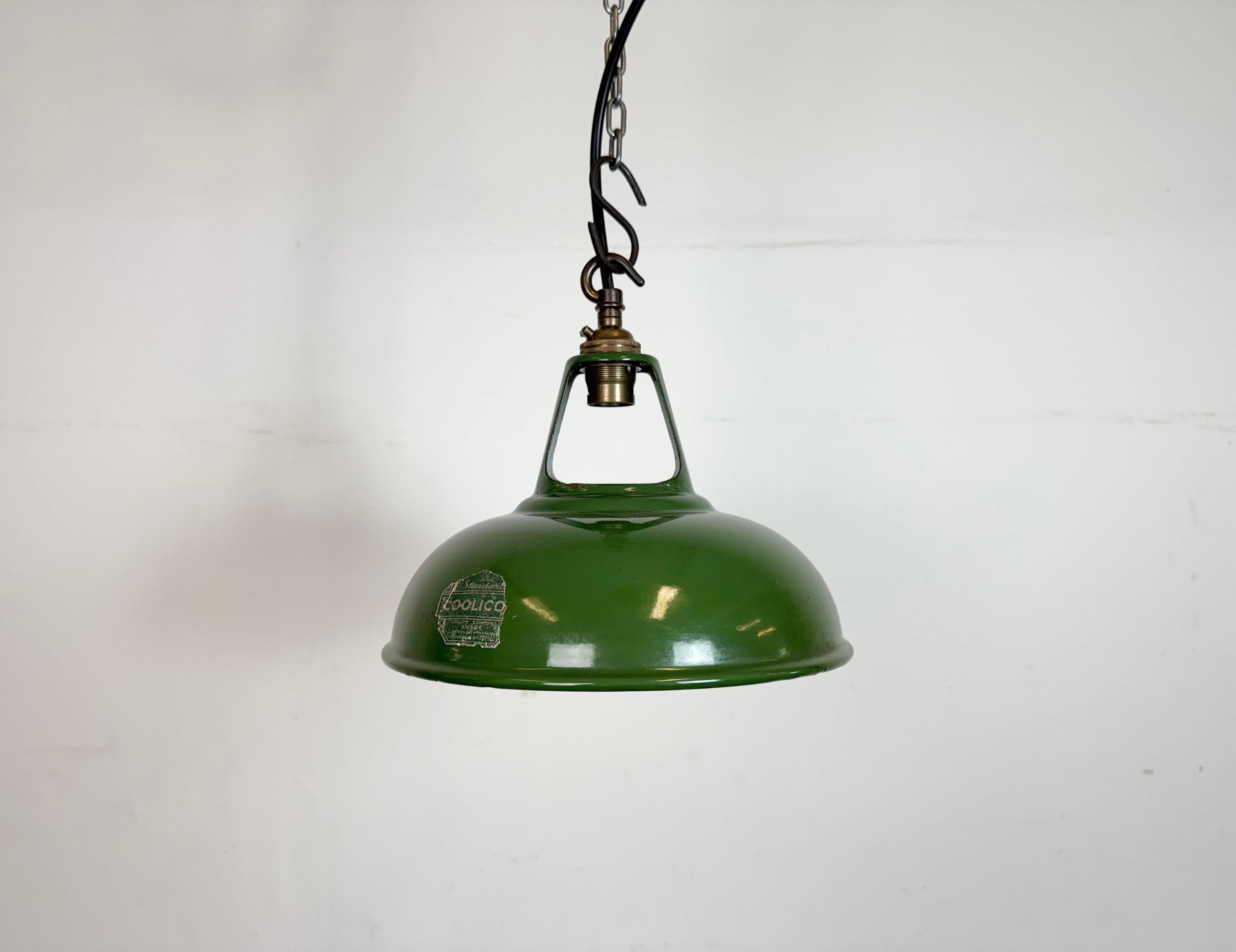 Industrial green enamel pendant light made by Coolicon in United Kingdom during the 1950s. White enamel inside the shade. Brass top. The socket requires  B22 light bulbs. New wire. The weight of the lamp is 0,4 kg.The diameter of the lamp is 23 cm.