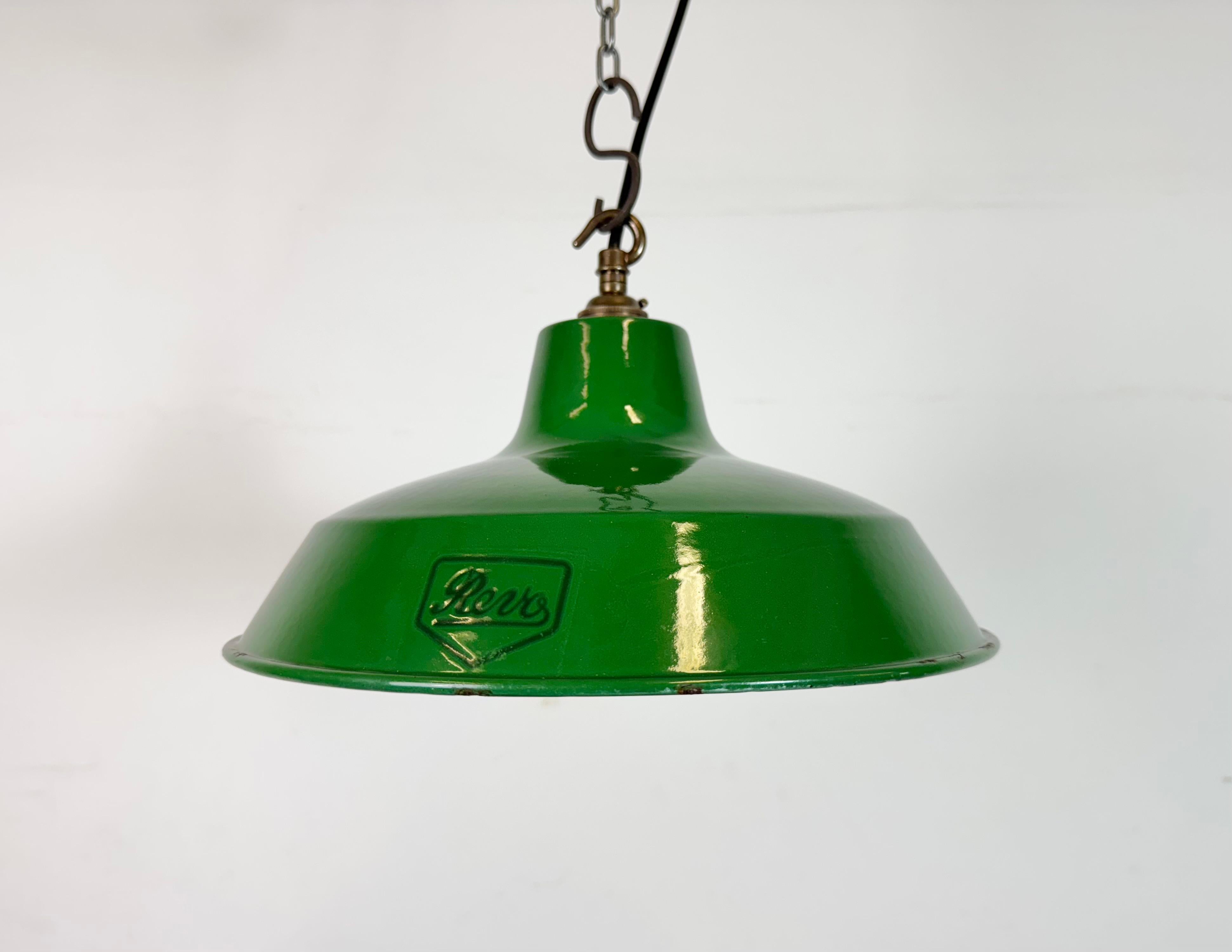 Industrial green enamel pendant light made by Revo in United Kingdom during the 1950s. White enamel inside the shade. Brass top. The socket requires  B22 light bulbs. New wire. The weight of the lamp is 0,8 kg.The diameter of the shade is 30 cm