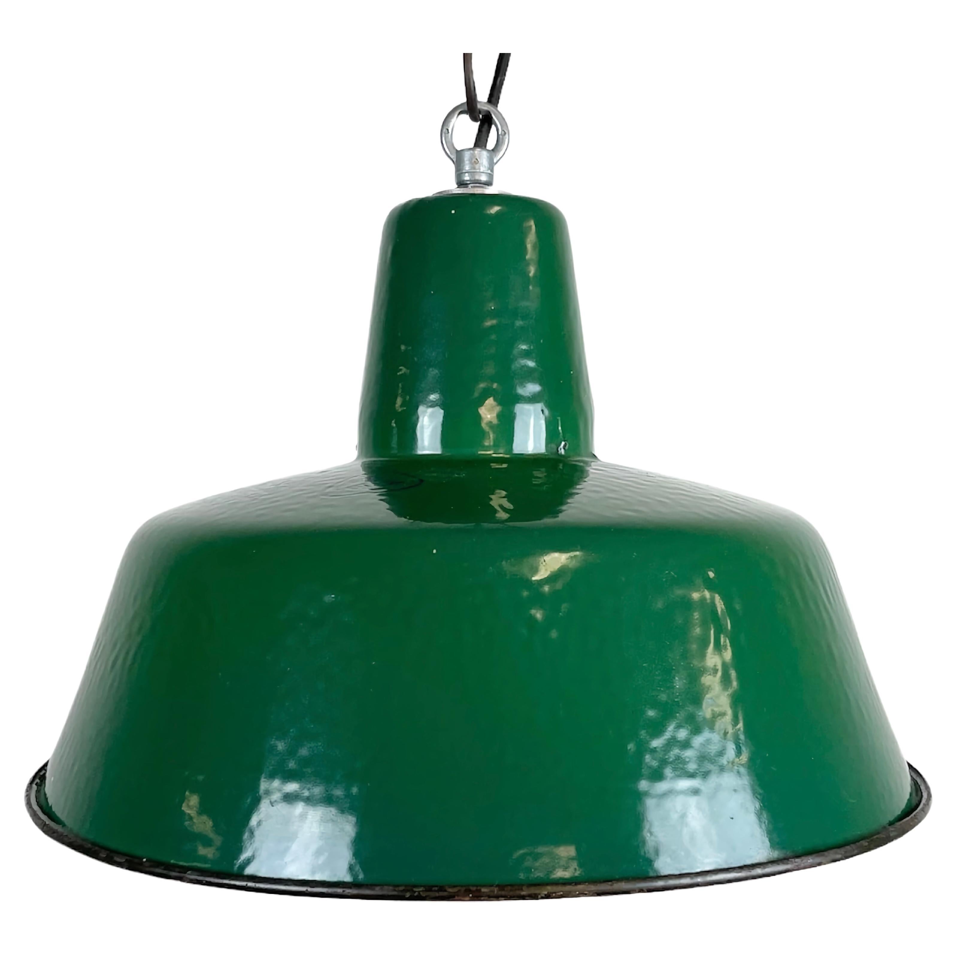 Industrial green enamel pendant light made by Polam Wilkasy in Poland during the 1960s. White enamel inside the shade. Iron top. The porcelain socket requires E 27 light bulbs. New wire. Fully functional. The weight of the lamp is 1,2 kg.
