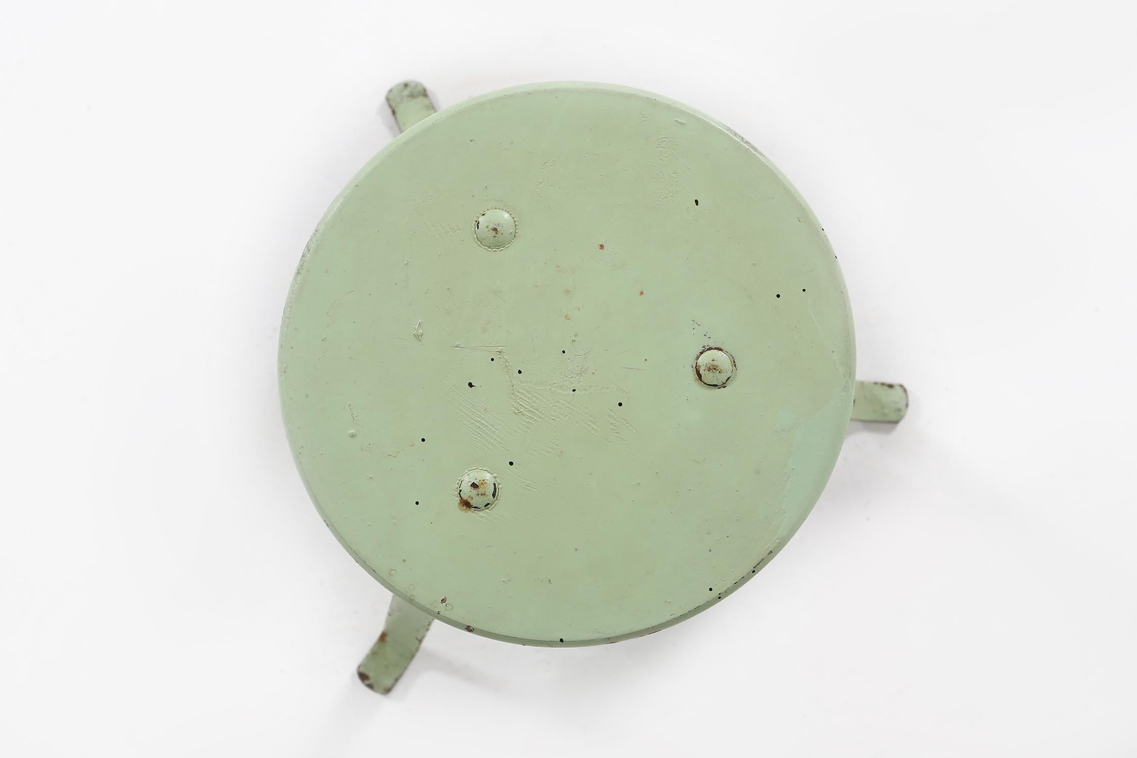 French Industrial green painted stool with steel base and wooden top, France 1930s For Sale