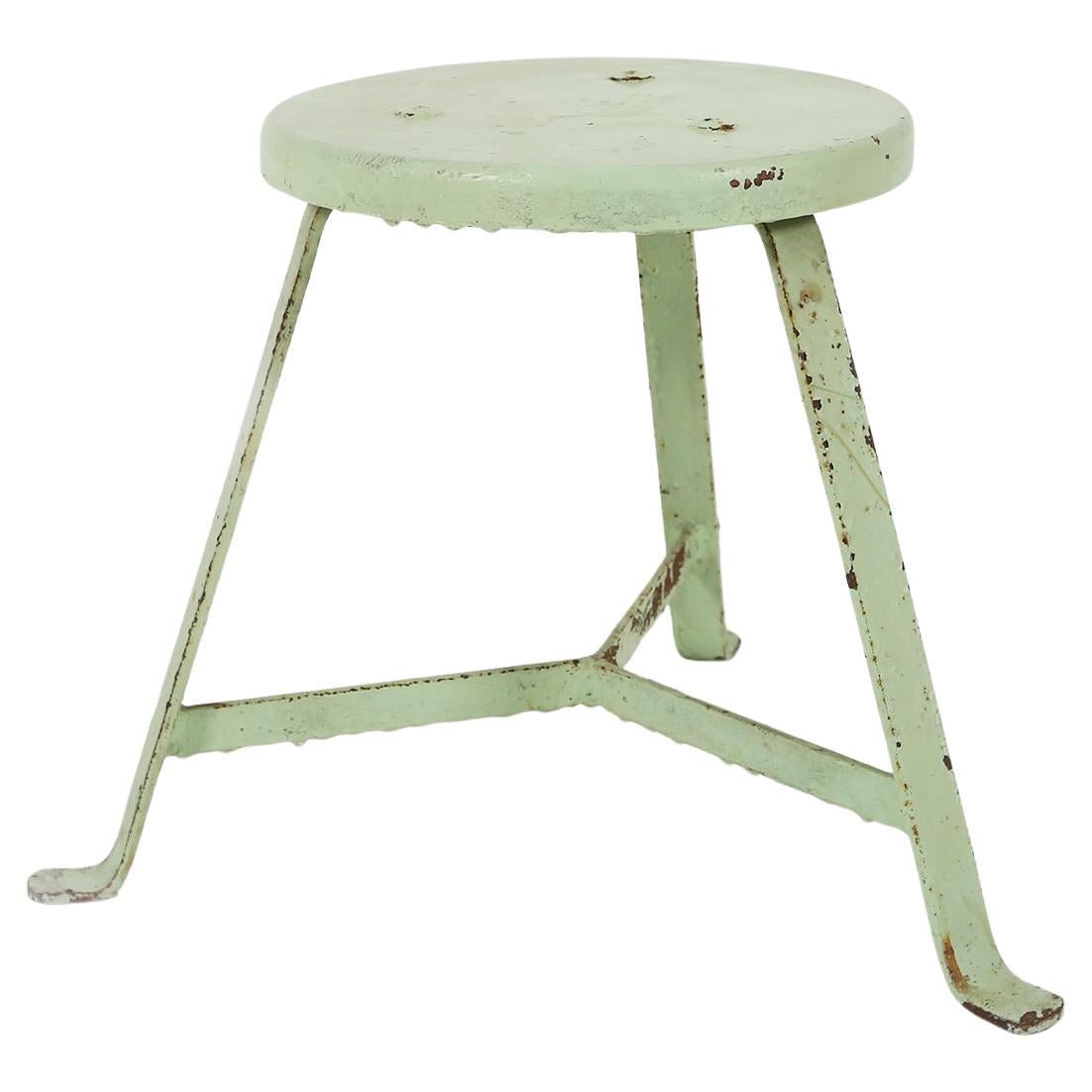 Industrial green painted stool with steel base and wooden top, France 1930s For Sale