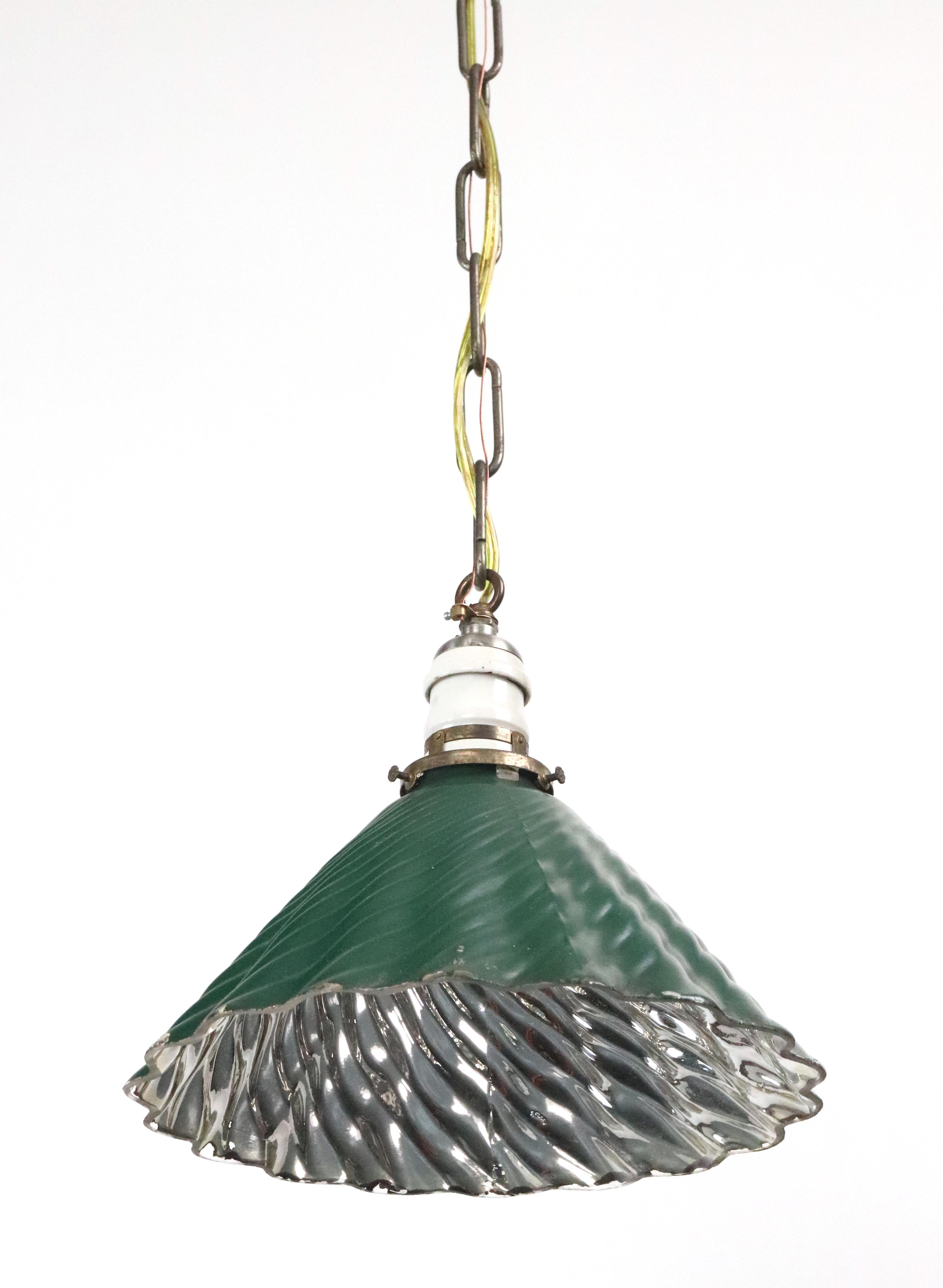 Industrial style pendant light with a wavy mercury glass shade coated in a vibrant green color, paired with a nickel finished chain and a black canopy. The green mercury glass shade is made by X-Ray. This requires one standard Edison style medium