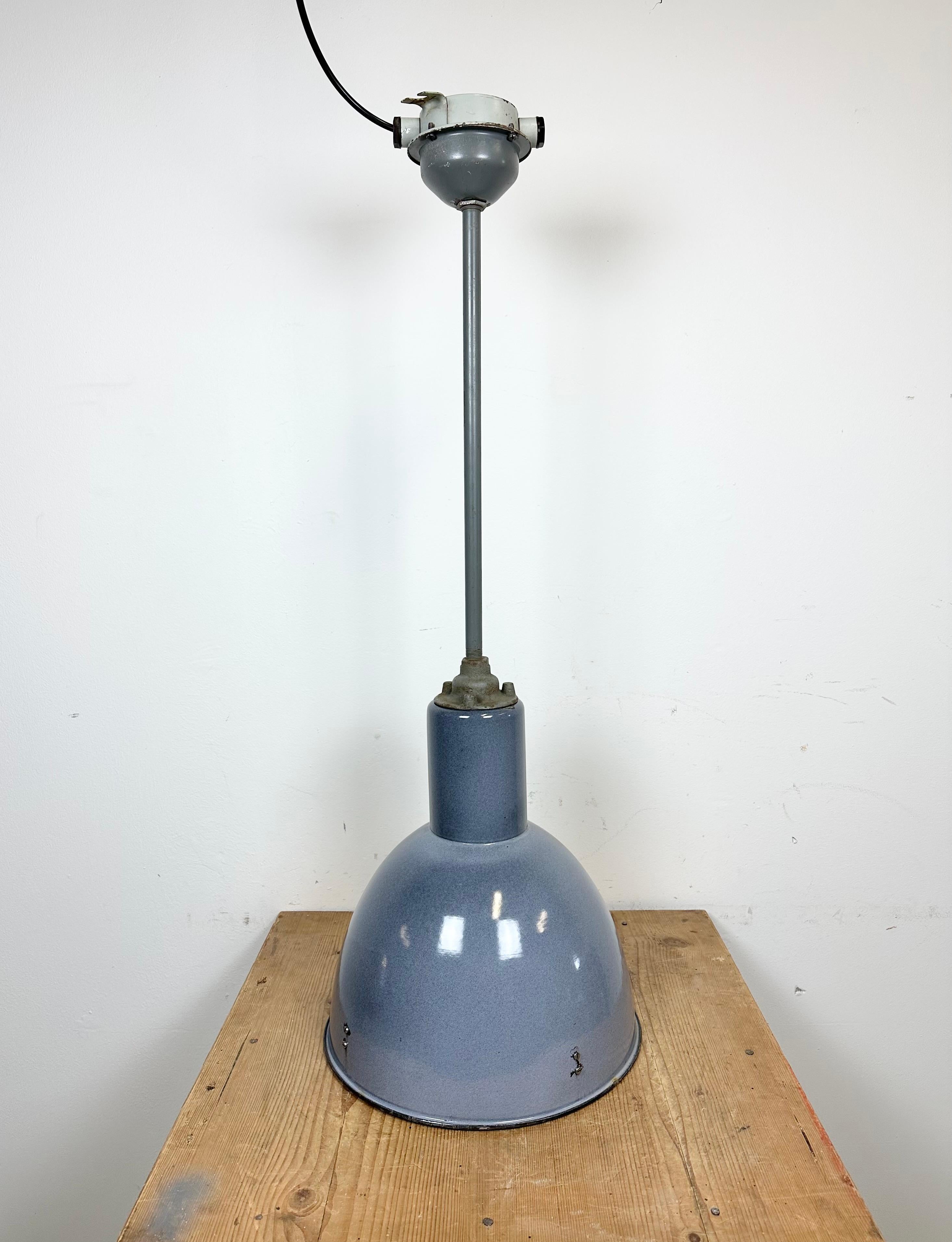 Vintage industrial enamel ceiling lamp made by Elektrosvit in former Czechoslovakia during the 1950s. It features a grey ( blue ) enamel shade with white enamel interior and iron ceiling mounting. New porcelain socket requires E 27/ E 26 light