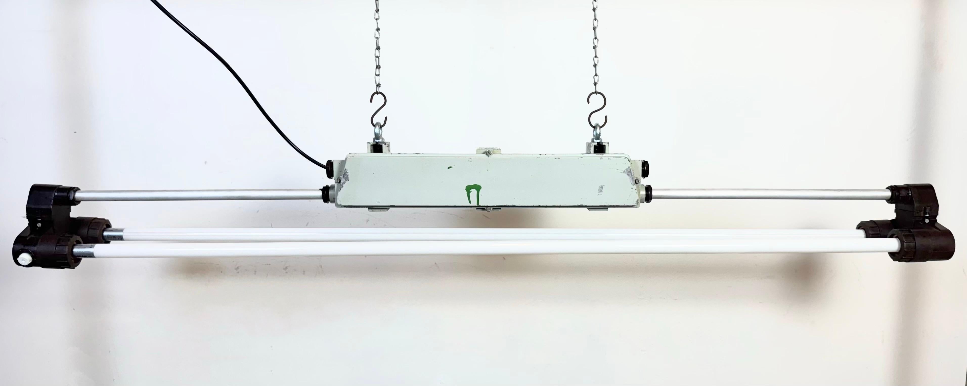 This industrial cast aluminium and bakelite light was made by Elektrosvit during the 1970s in former Czechoslovakia. These fixtures were used in laboratories and chemical and industrial plants. The light requires two LED T8, 150 cm light tubes. The