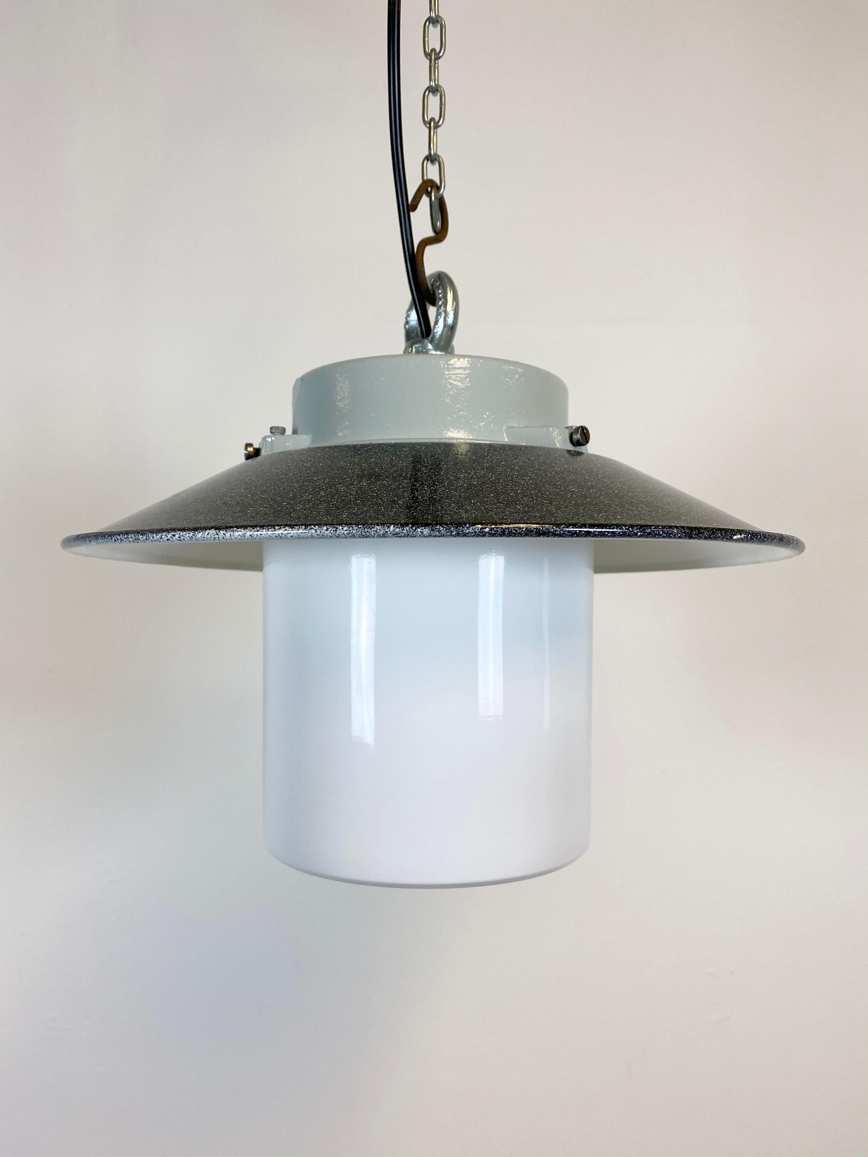 Vintage Industrial lamp from 1970s. Cast aluminium top. Enamel shade. Milk glass. New porcelain socket for E 27 lightbulbs and wire. Weight: 2 kg.