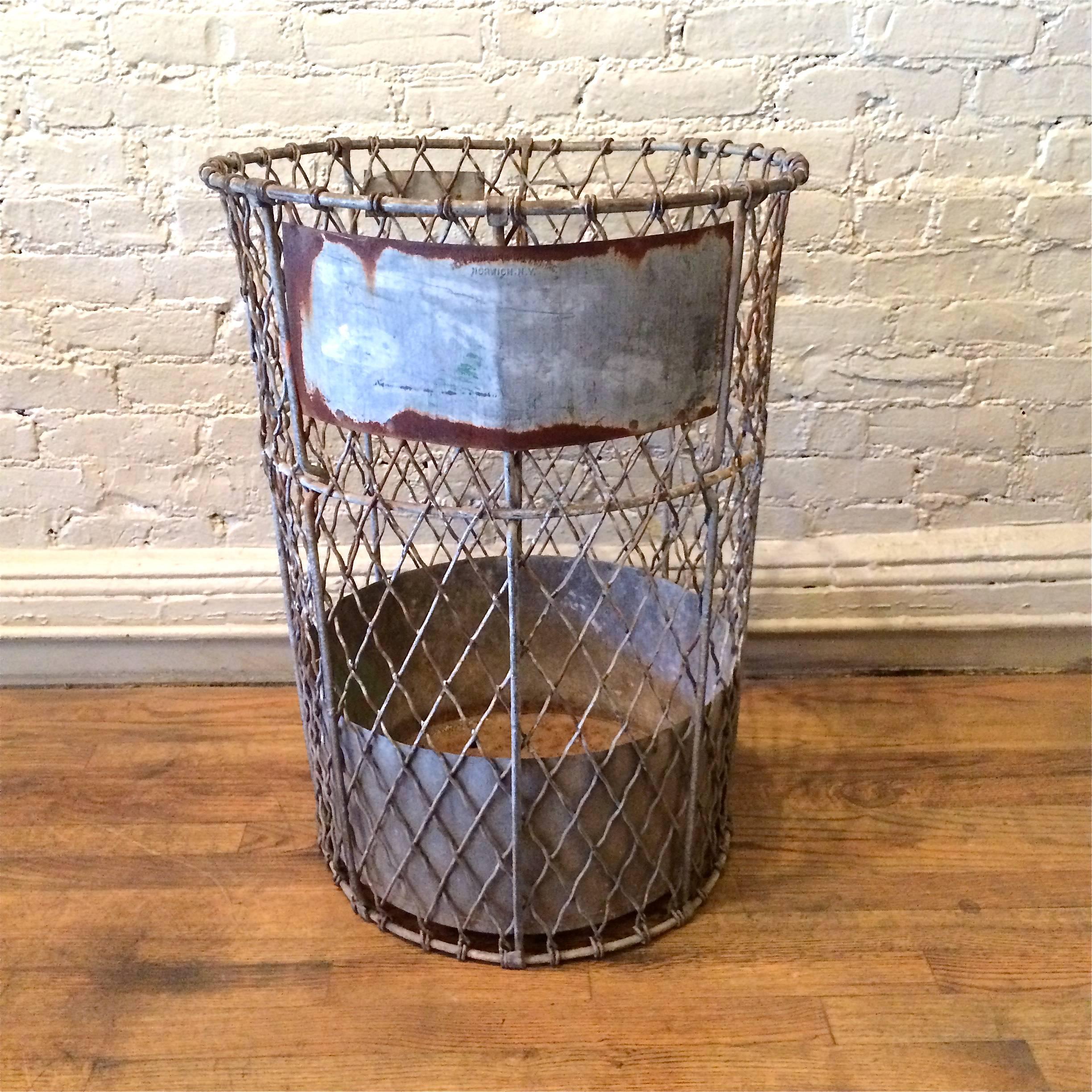 Tall, industrial, heavy gauge, galvanized steel, metal mesh, waste basket by Norwich Wire Works, Inc., Norwich NY.