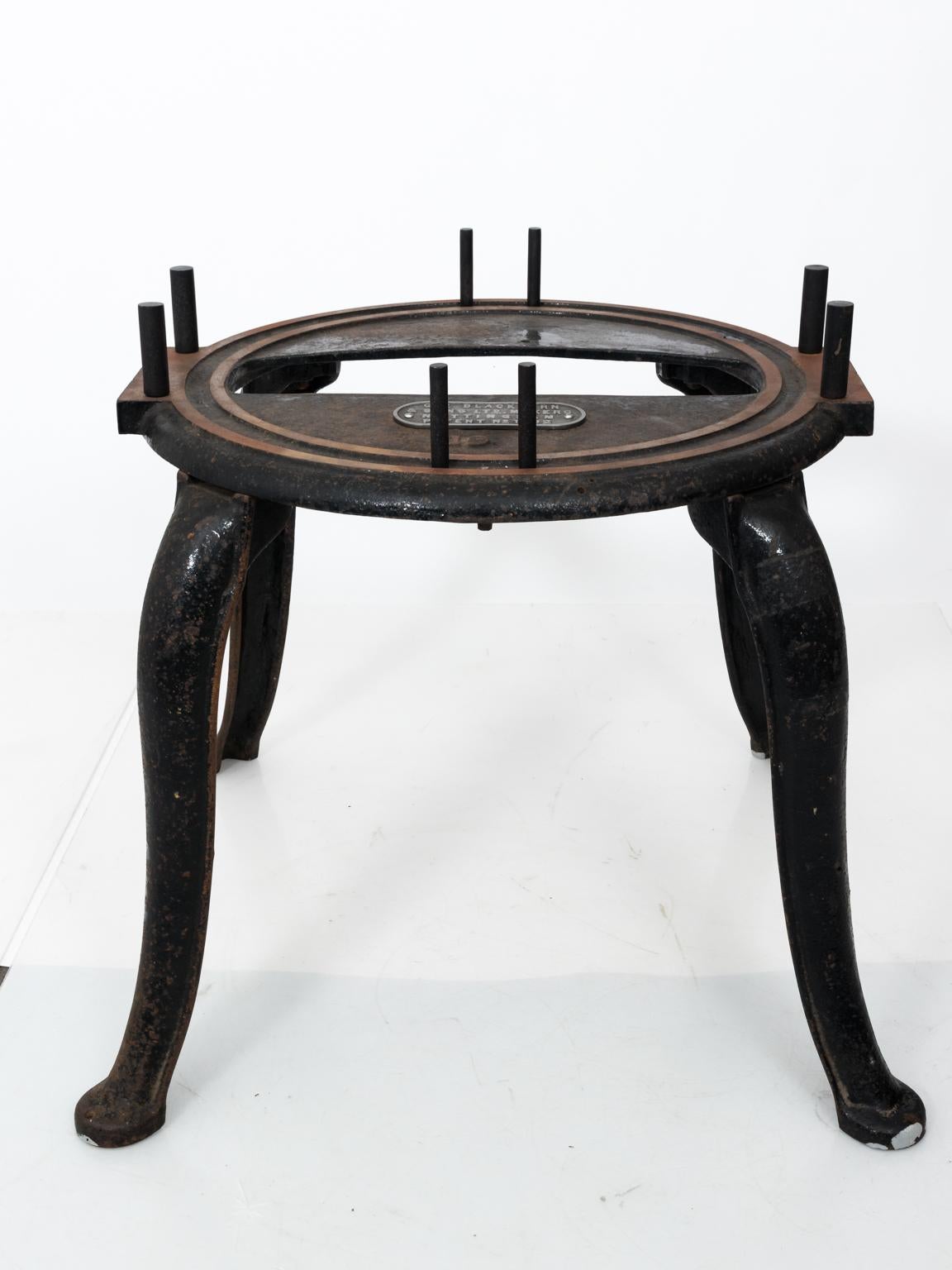 Iron base center table with new glass top made from a reclaimed Industrial piece from Nottingham, England, circa 20th century. The base has a plaque that reads 