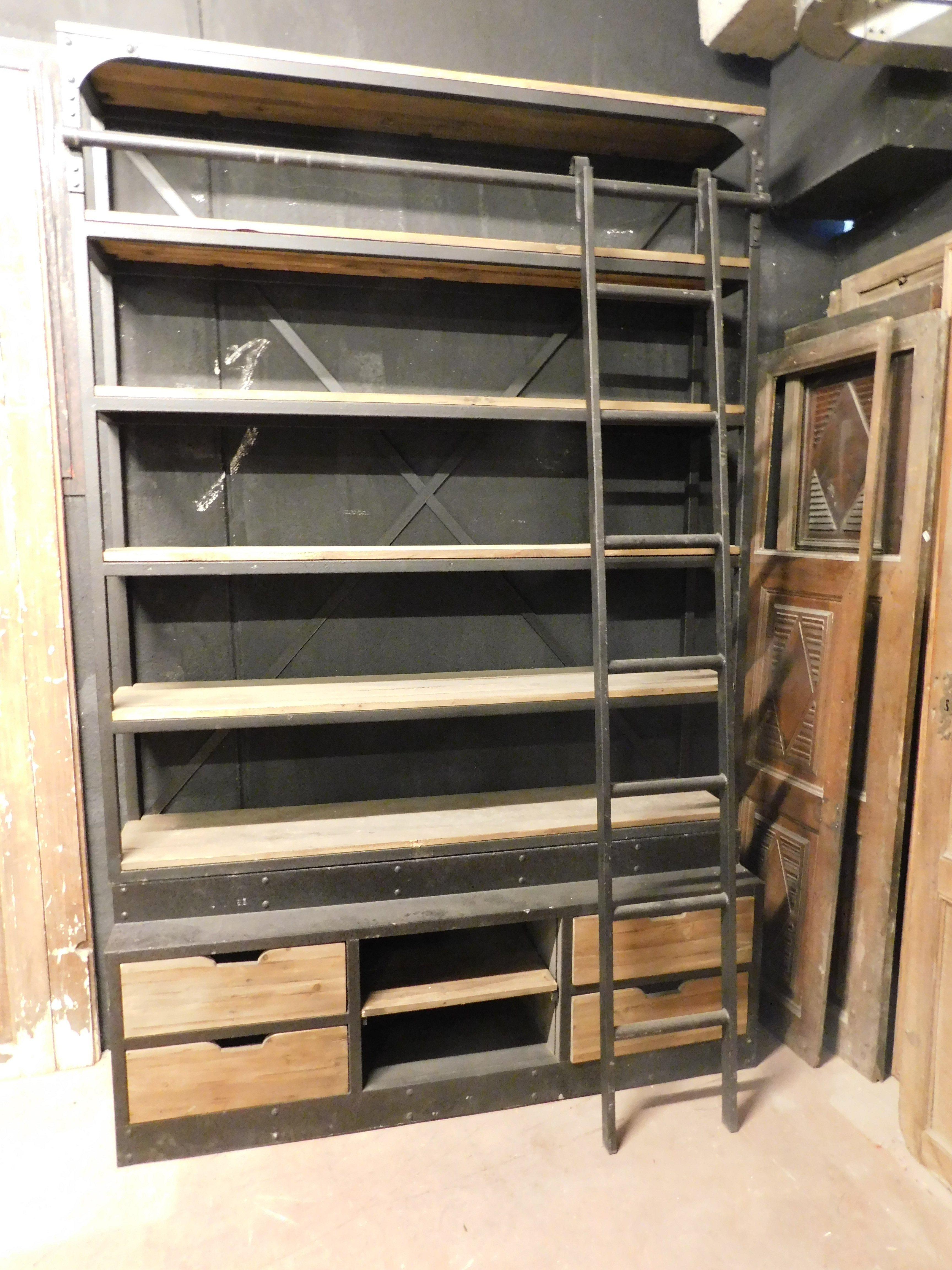 Italian Industrial iron bookcase with wooden shelves and drawers complete with ladder For Sale