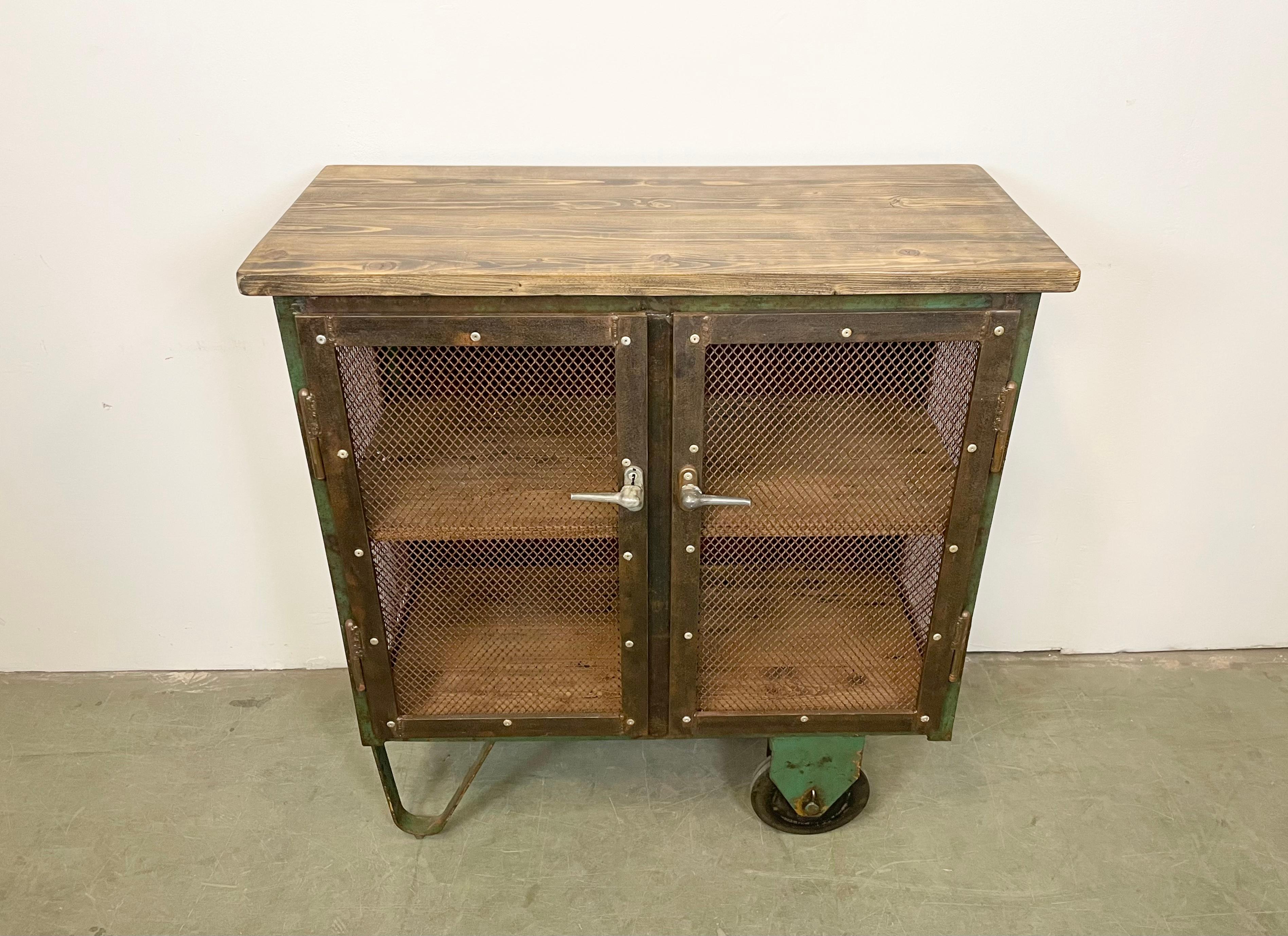 Czech Industrial Iron Cabinet with Mesh Doors on Wheels, 1960s