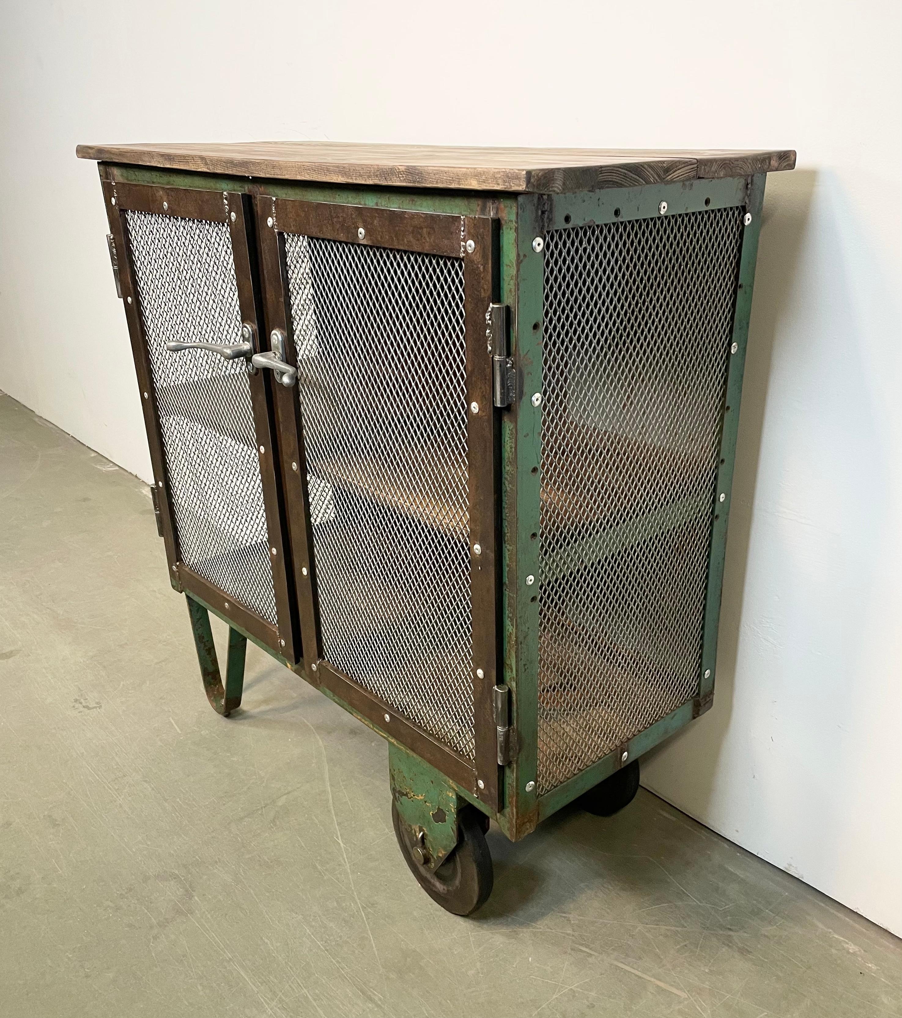 Czech Industrial Iron Cabinet with Mesh Doors on Wheels, 1960s For Sale