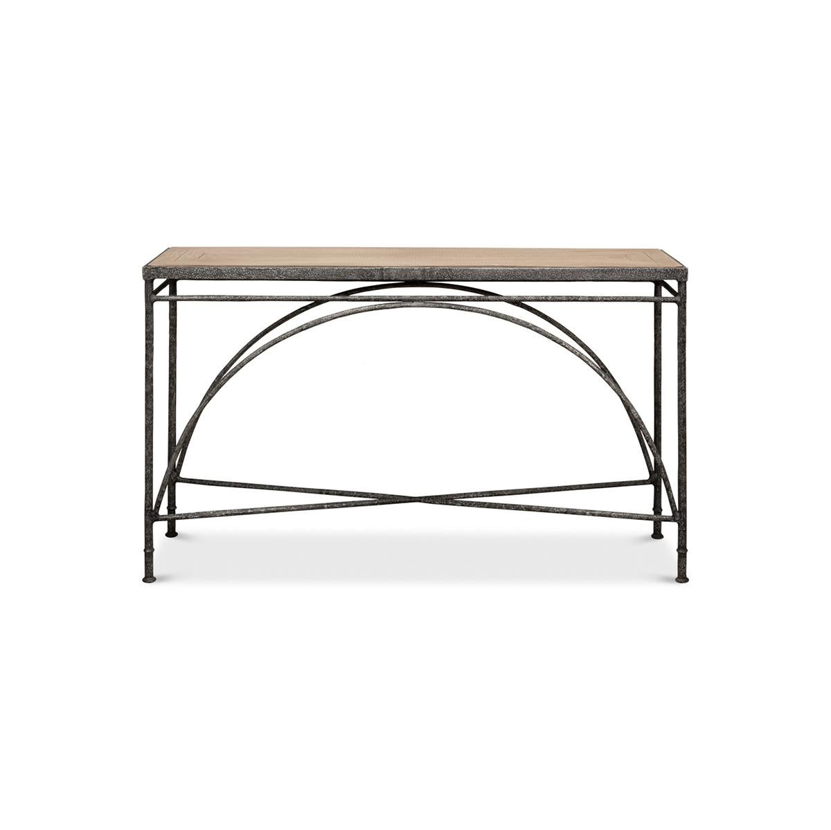 Industrial iron console table with a pine veneered top and cast iron frame base, with an arched central support and a stretcher base.

Dimensions: 54