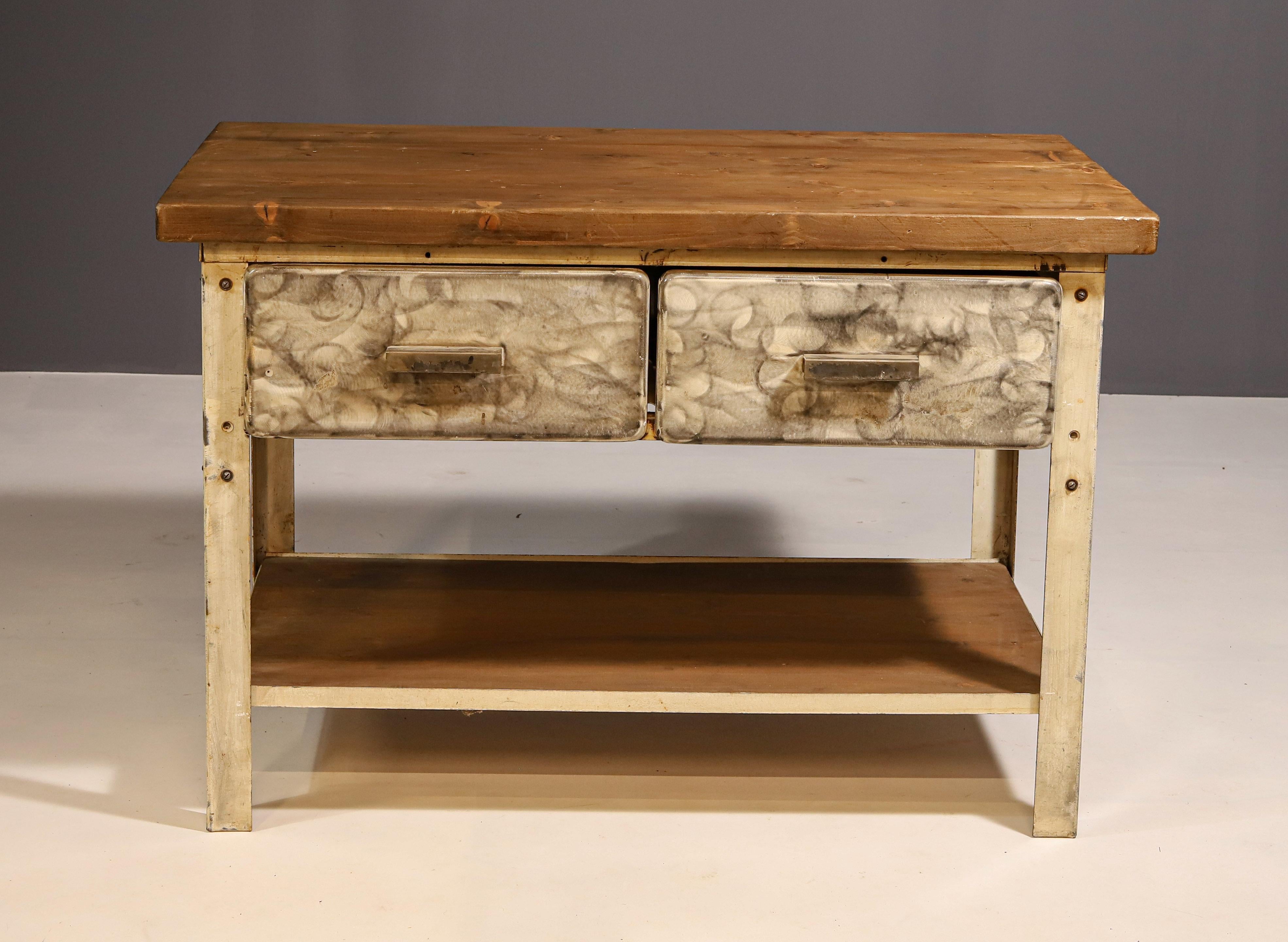 This industrial kitchen table was made in the former Czechoslovakia in the 1950´s

It´s made of iron with wooden plate on the table top.

The table is overall in good vintage condition, it shows signs of wear and tear, nice patina.


