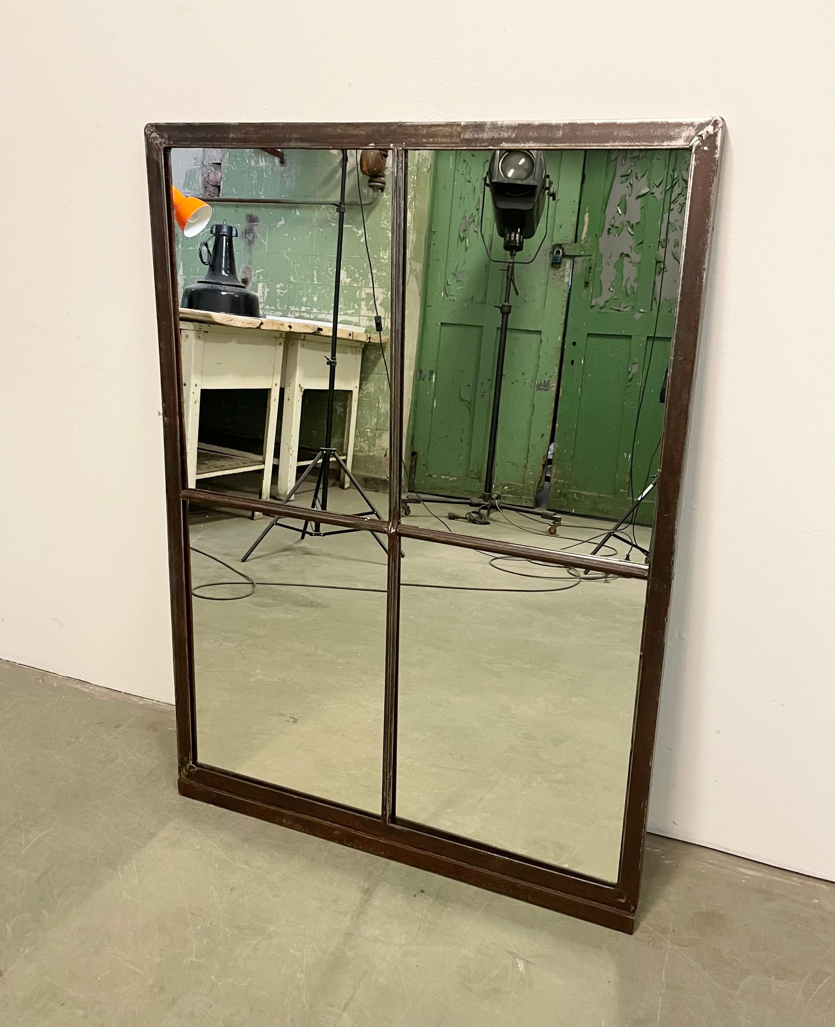 This iron industrial window frame has been transformed into a mirror. The weight of the mirror is 17 kg.