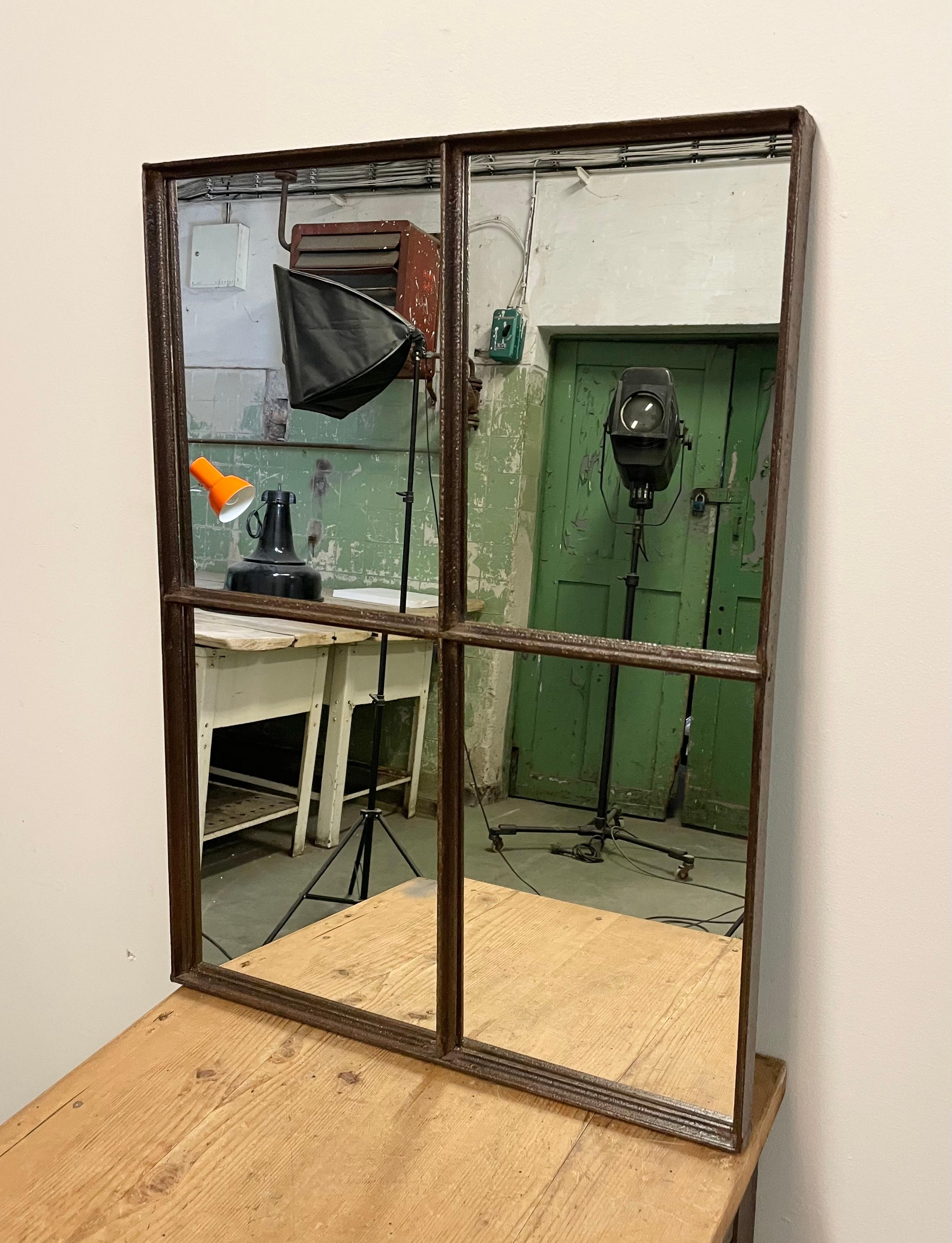 This iron industrial window frame has been transformed into a mirror. The weight of the mirror is 17 kg.