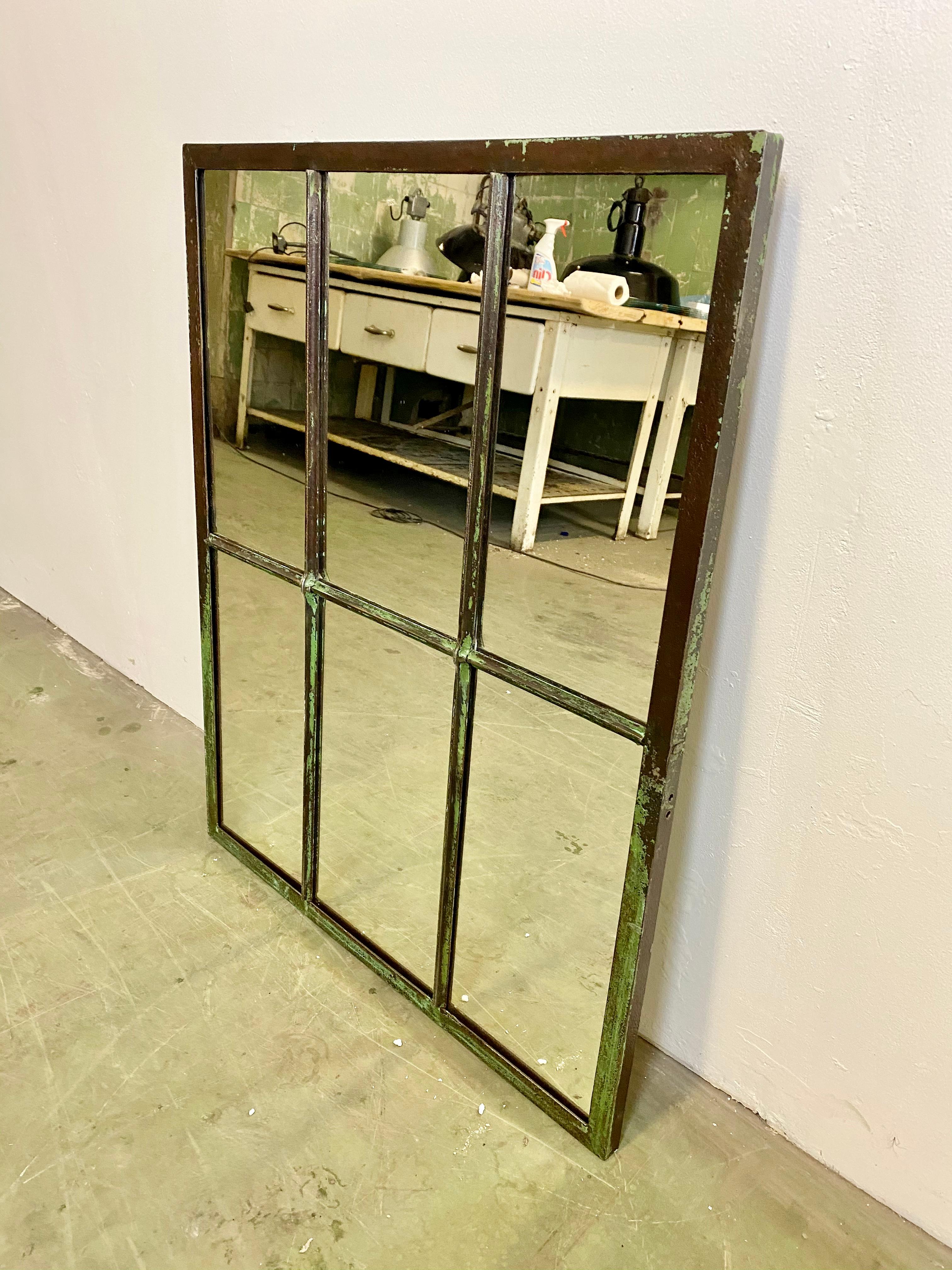 This iron industrial window frame has been transformed into a mirror. The weight of the mirror is 15 kg.