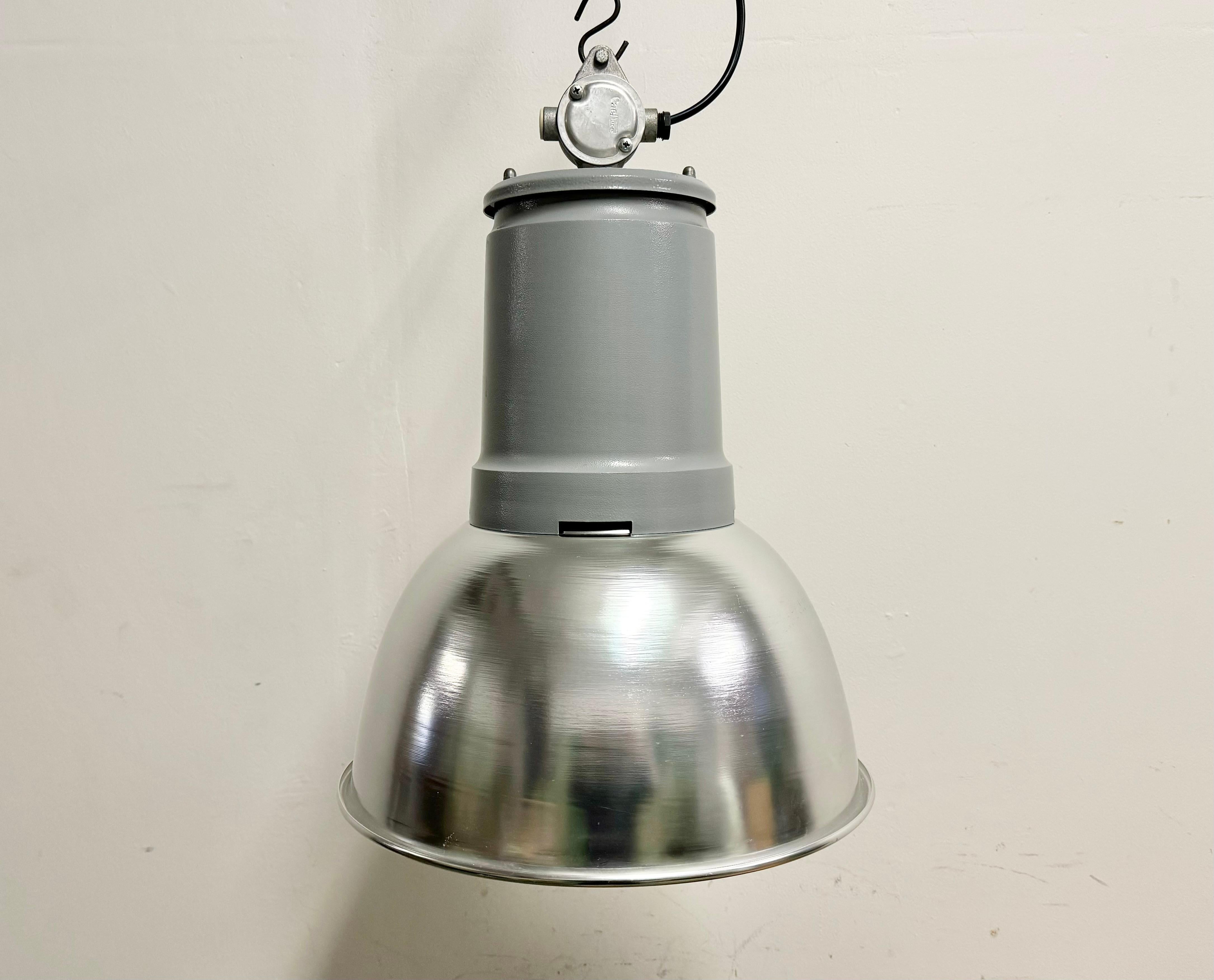 This pendant light was made by Fael Luce in Italy during the 1970s. The piece is comprised of an aluminium lampshade and an iron top with cast aluminium box. The lamp is fully functional and features a new porcelain E27/ E26 socket and wire. The