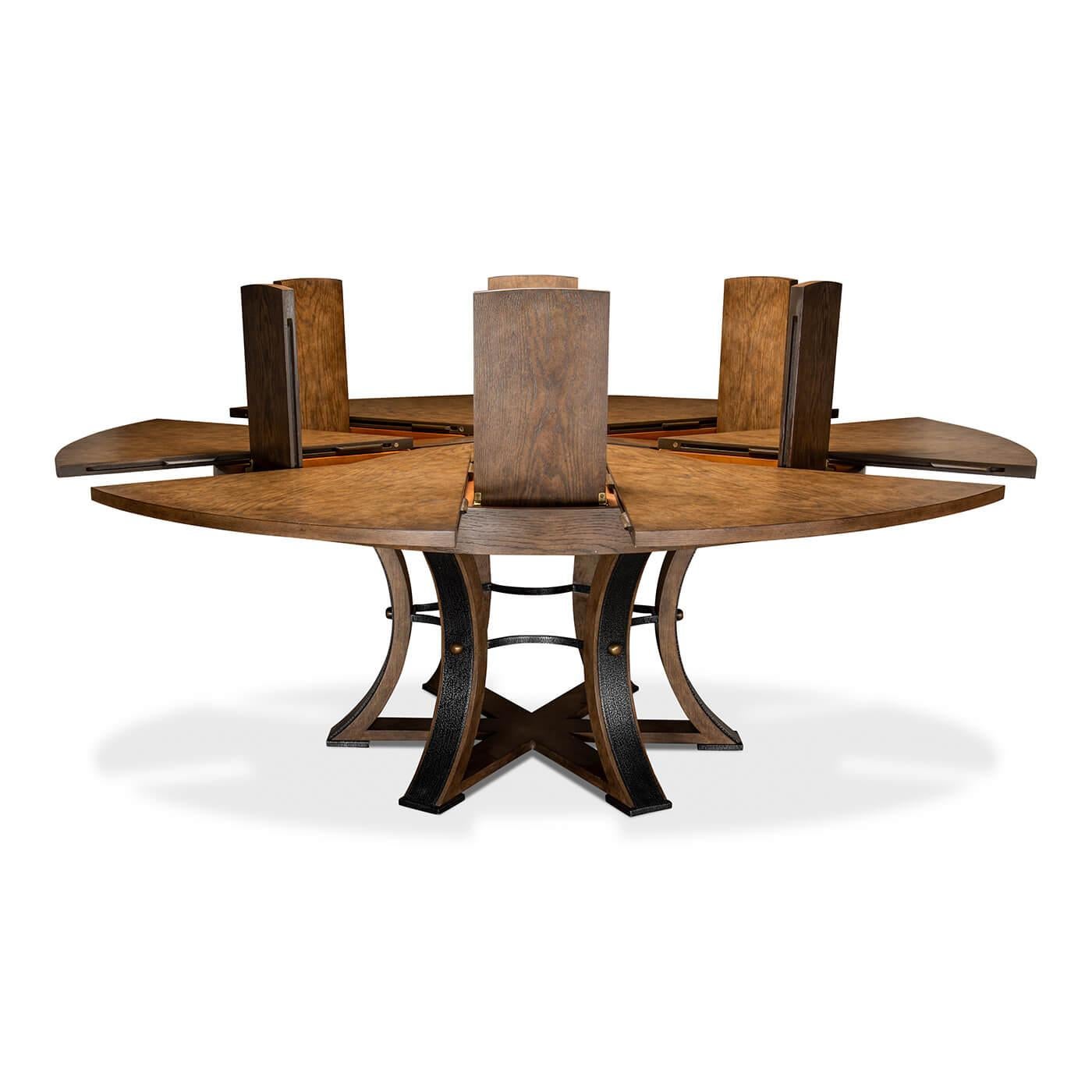 A modern Industrial style round extension dining table with a wire-brushed oak finish top, the round form self-storing leaves on a six-sided pedestal base with hammered iron mounts to each leg.

Measures: Open dimensions: 84