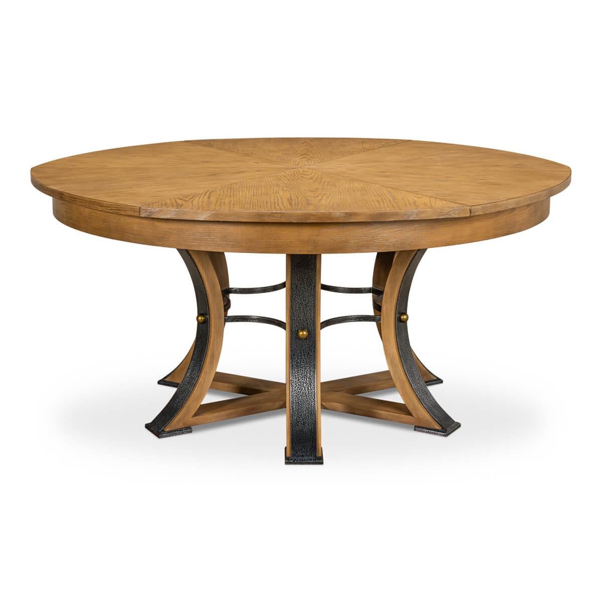 A modern industrial style extension dining table with a wire-brushed oak finish top, the Jupe form self-storing leaves on a six-sided pedestal base with hammered iron mounts to each leg.

Open dimensions: 84