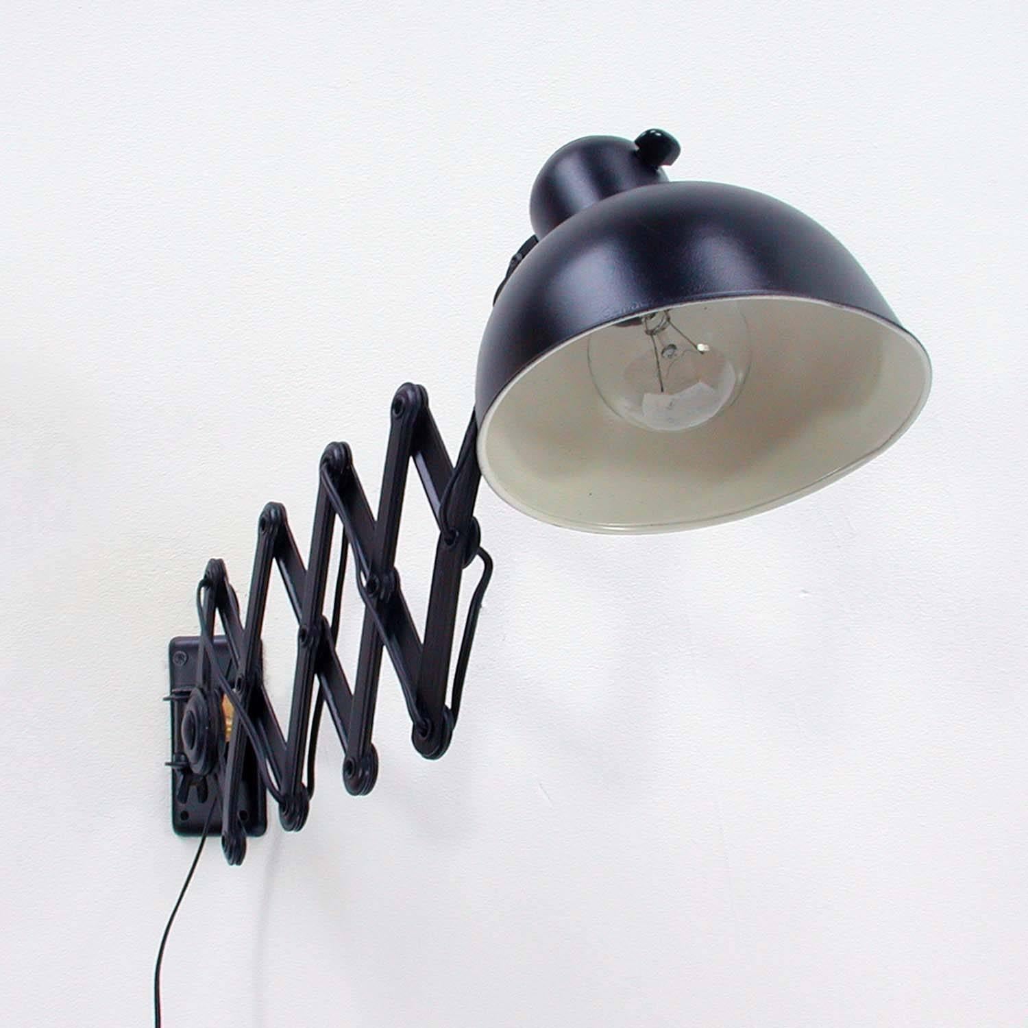 This black industrial scissors lamp (model no. 6718) was made in the 1930s and designed by Christian Dell for Kaiser Idell in Germany during the Bauhaus period. It is now regarded as a design classic.

The lamp has the original Kaiser Idell