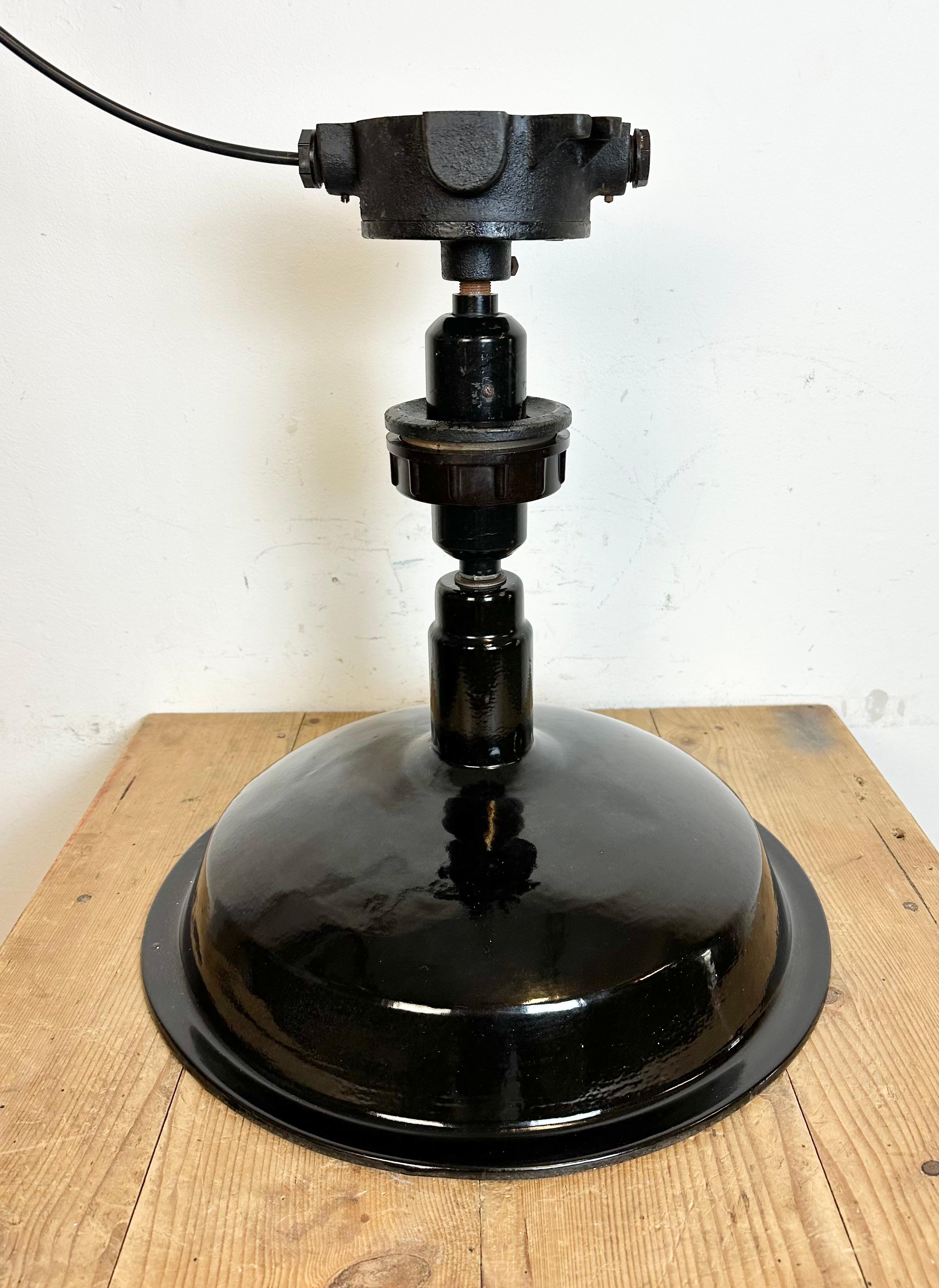 Vintage industrial enamel ceiling lamp made by Elektrosvit in former Czechoslovakia during the 1950s. It features a black enamel shade with white enamel interior and cast iron ceiling mounting. New porcelain socket requires standard E 27/ E 26 light