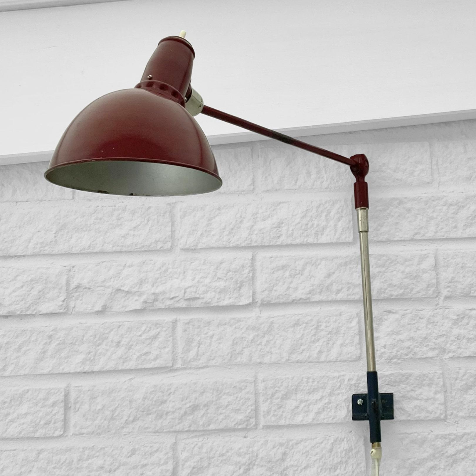 A table or wall lamp model Triplex Lillpendel type TP, developed by the Swedish inventor Johan Petter Johansson. Constructed from steel and aluminum, painted deep red with chrome details. This smaller model of the Triplex lamp was designed to be