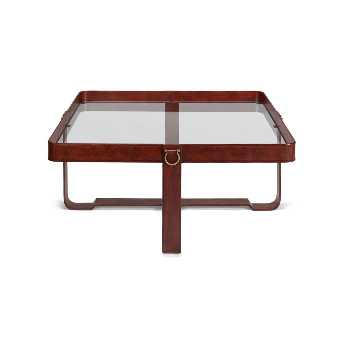 With an inset glass top and a brown leather-wrapped frame and base.

Dimensions: 40