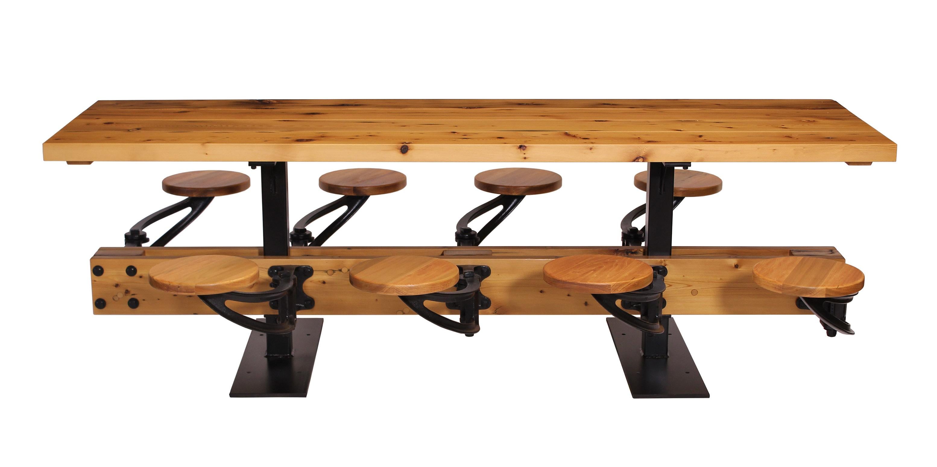 Library / Communal / Industrial dining table with reclaimed pine (douglas fir) and cast iron swing-out seats. Can be built with four to twenty four (or more) seats. Tables can be linked together. Handcrafted steel pedestals are fitted with mounting
