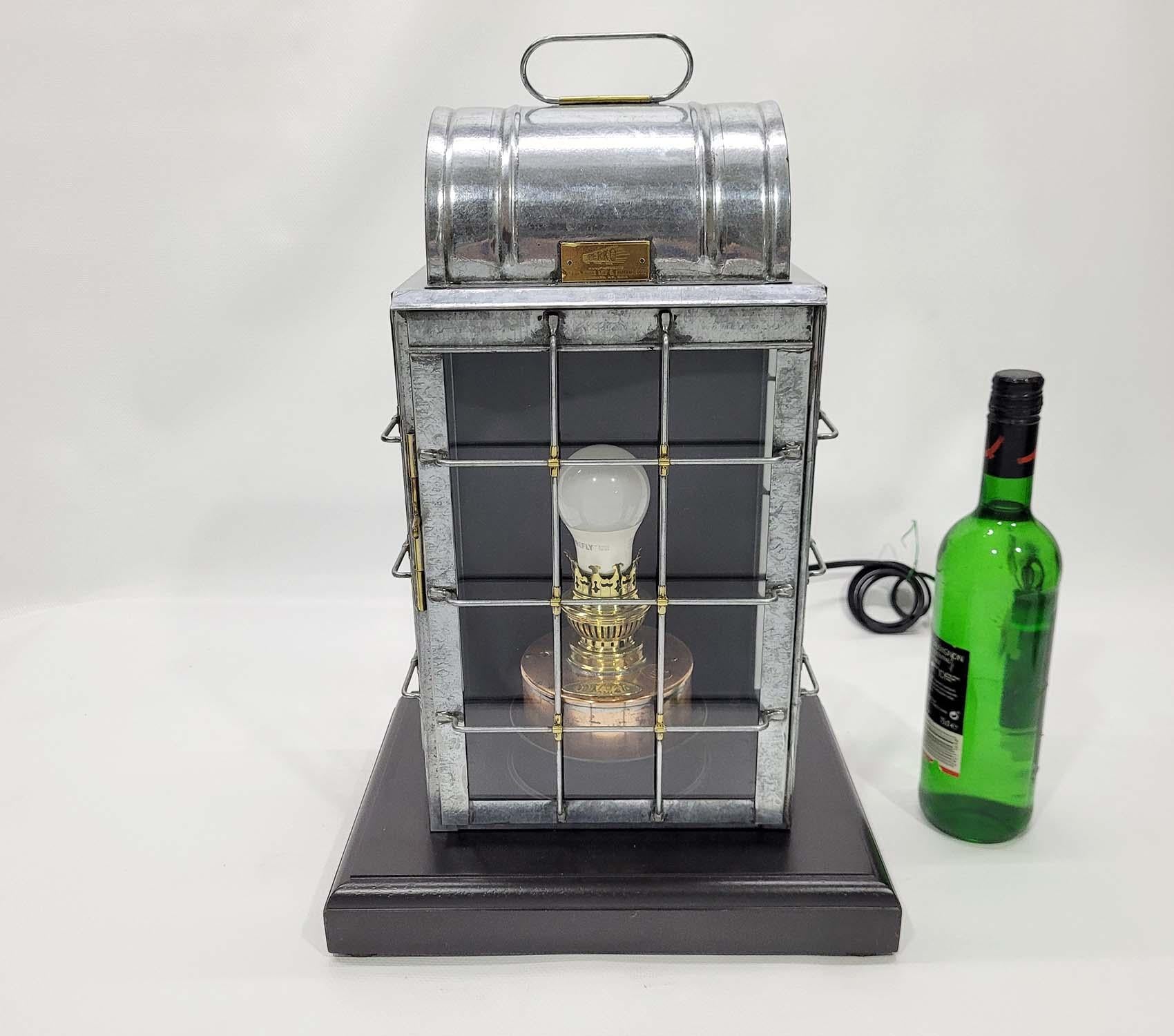 Ships lantern with brass makers from Perko, Perkins Marine Lamp and Hardware Corporation, Brooklyn New York. The polished and lacquered case has a metal cage. The copper oil font has been retrofitted with an electric socket. Circa 1920

Weight: 11