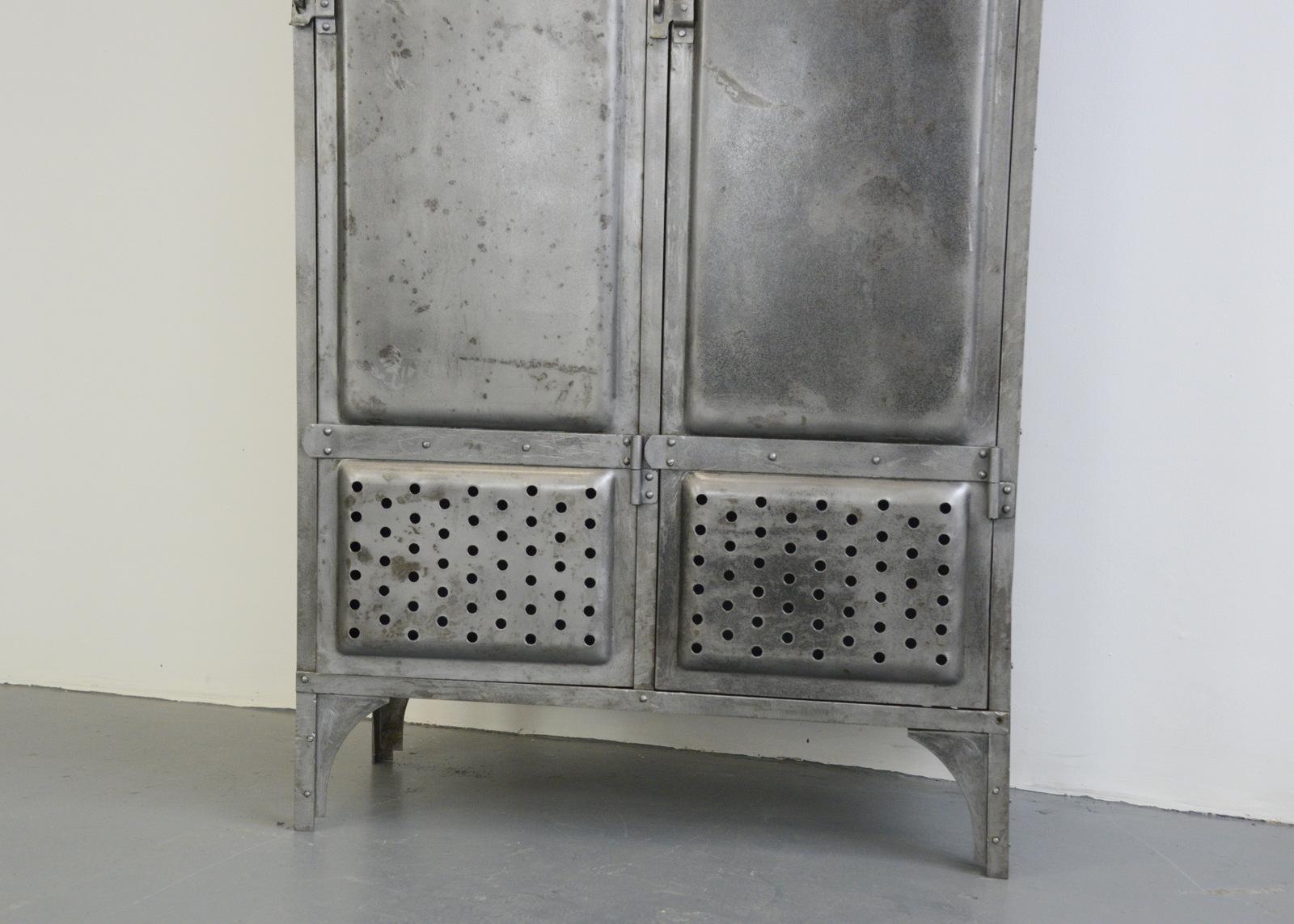 Industrial lockers by Kuppersbusch, circa 1920s

- Pressed steel doors
- Vented doors and bottom
- Porcelain door numbers
- Each locker has 4 shelves
- Made by Kuppersbusch
- German, 1920s
- Measures: 195cm tall x 86cm wide x 38cm