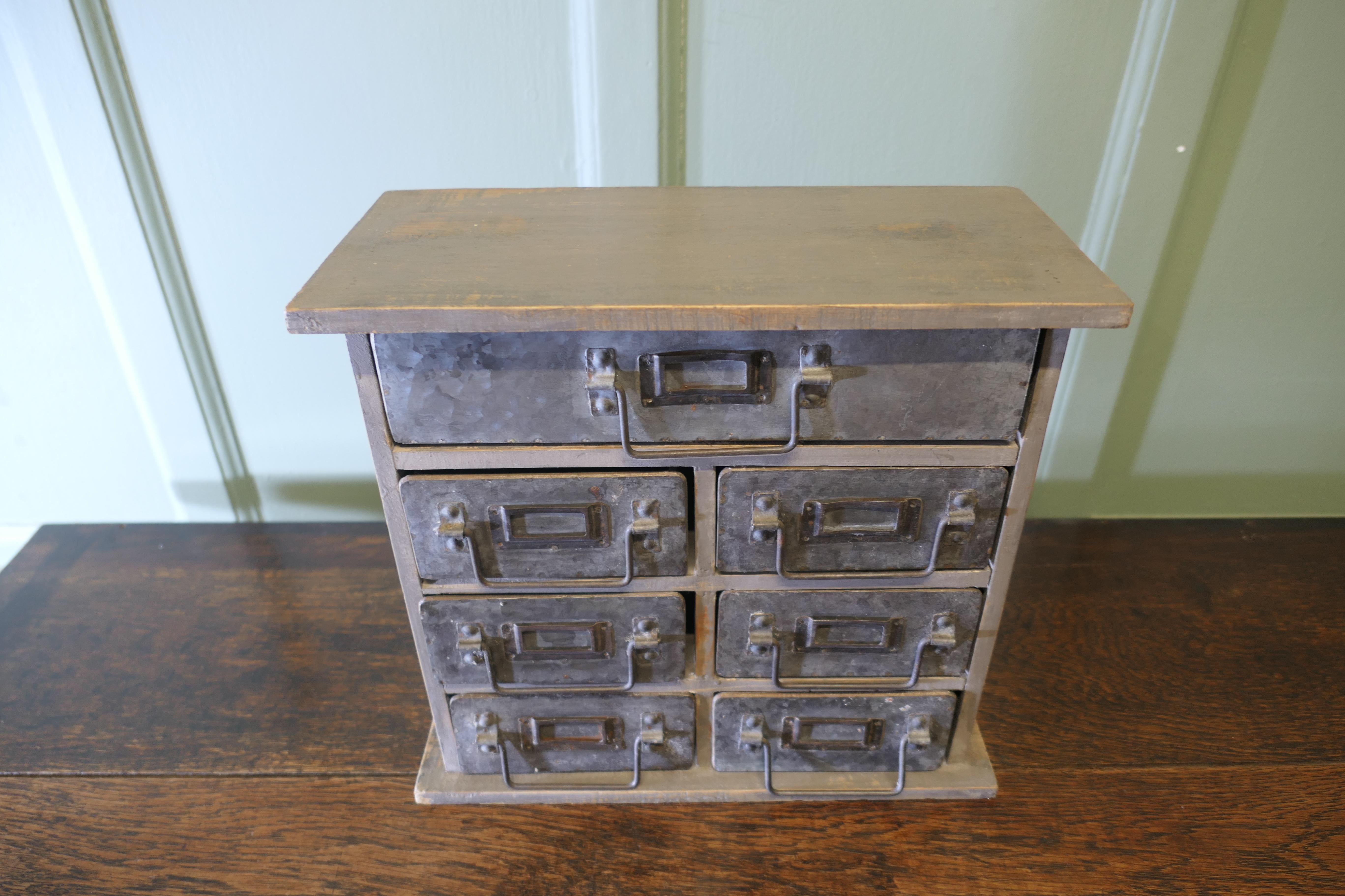 Industrial Look Metal Filing Drawers, Collector Cabinet

The wooden Cabinet has 7 metal fronted drawers, each with a small drop handle and a label holder
The cabinet is in sound original condition all the drawers work very smoothly, his would make a