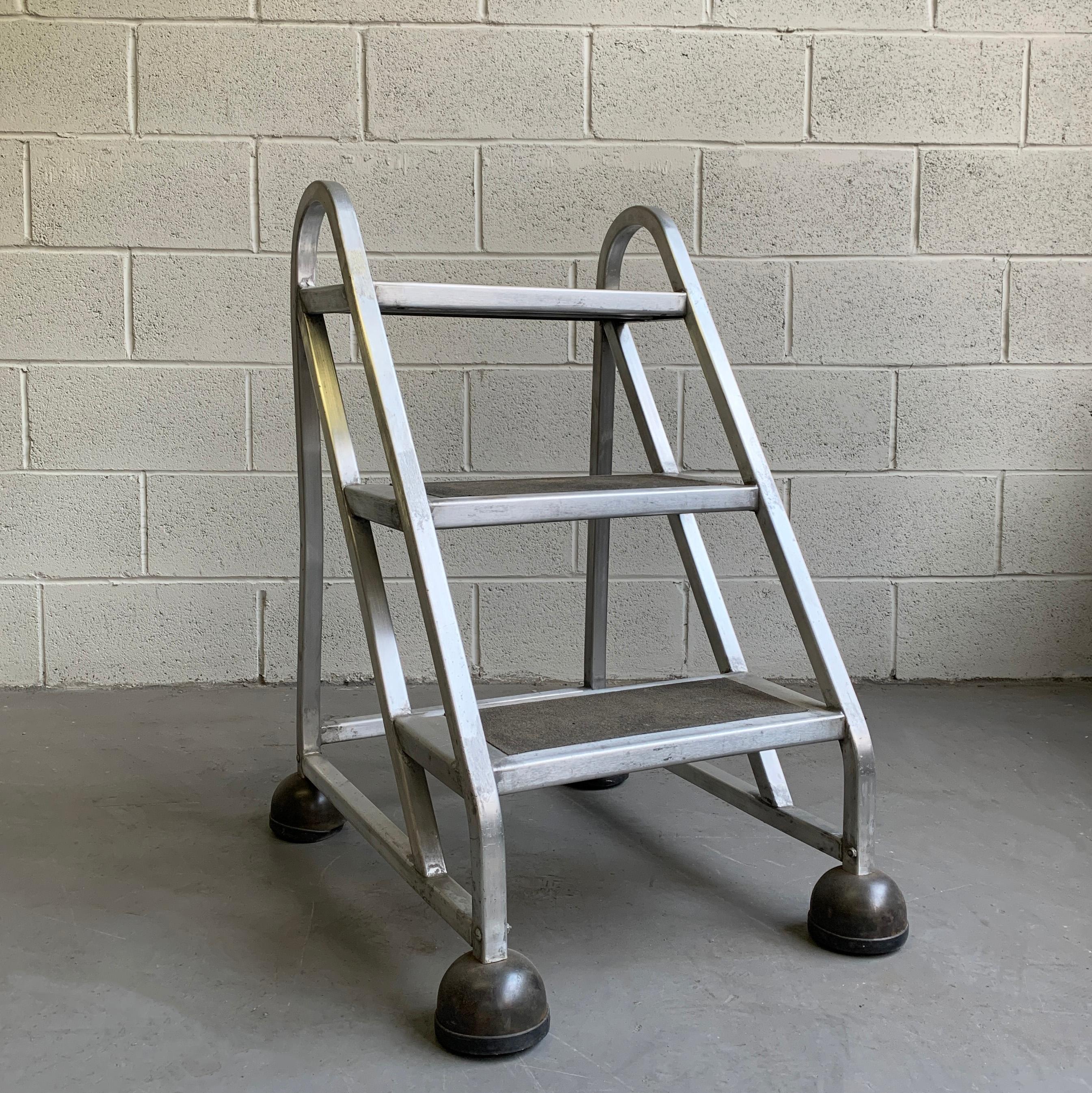 Practical and great looking, machine-age style, Industrial, A-frame, step ladder features covered rolling casters and covered steps.