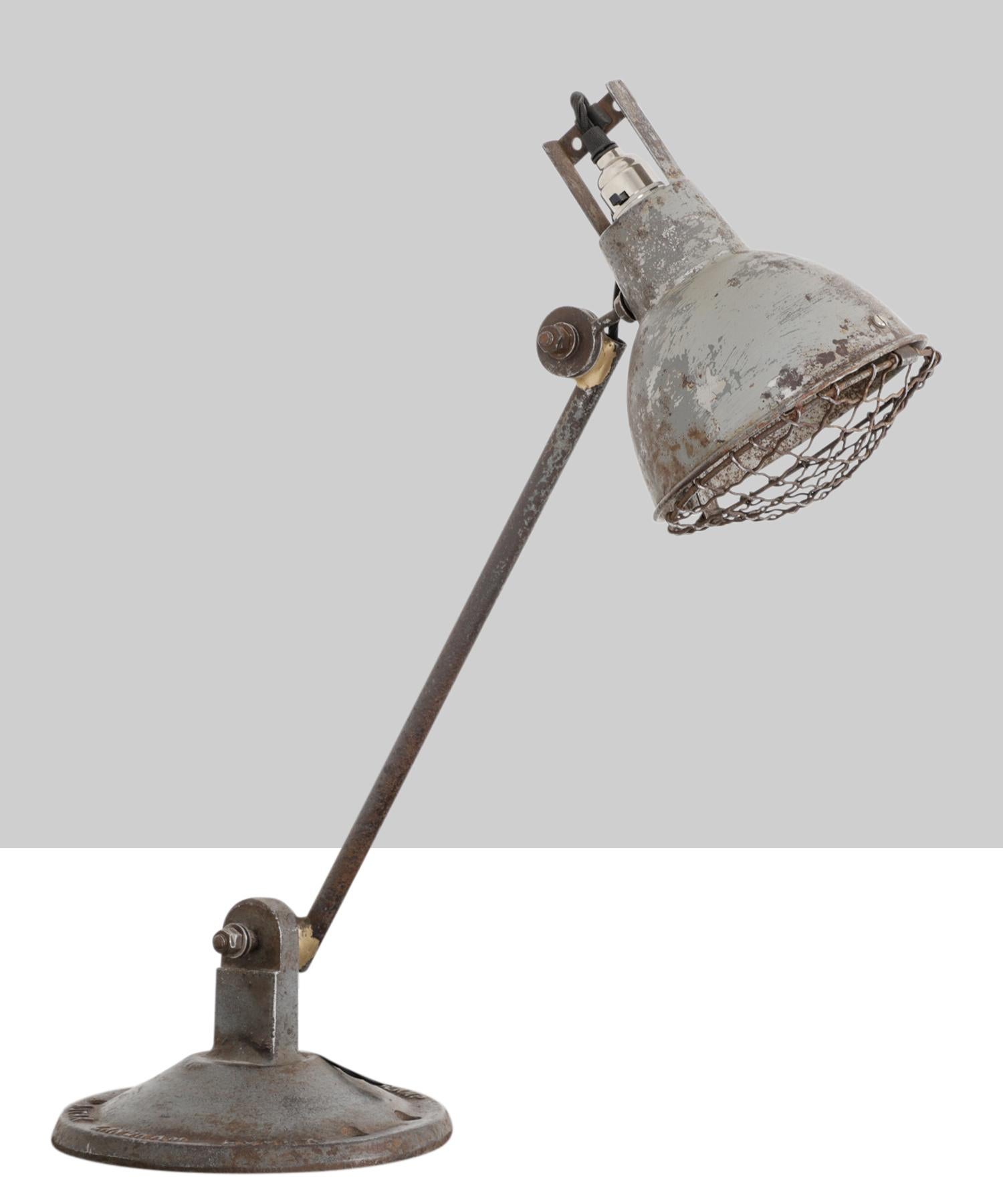 F.E.W. Handy-lamp by Autax Langham Essex. Single arm mounted to a cast iron base with articulating shade.

 