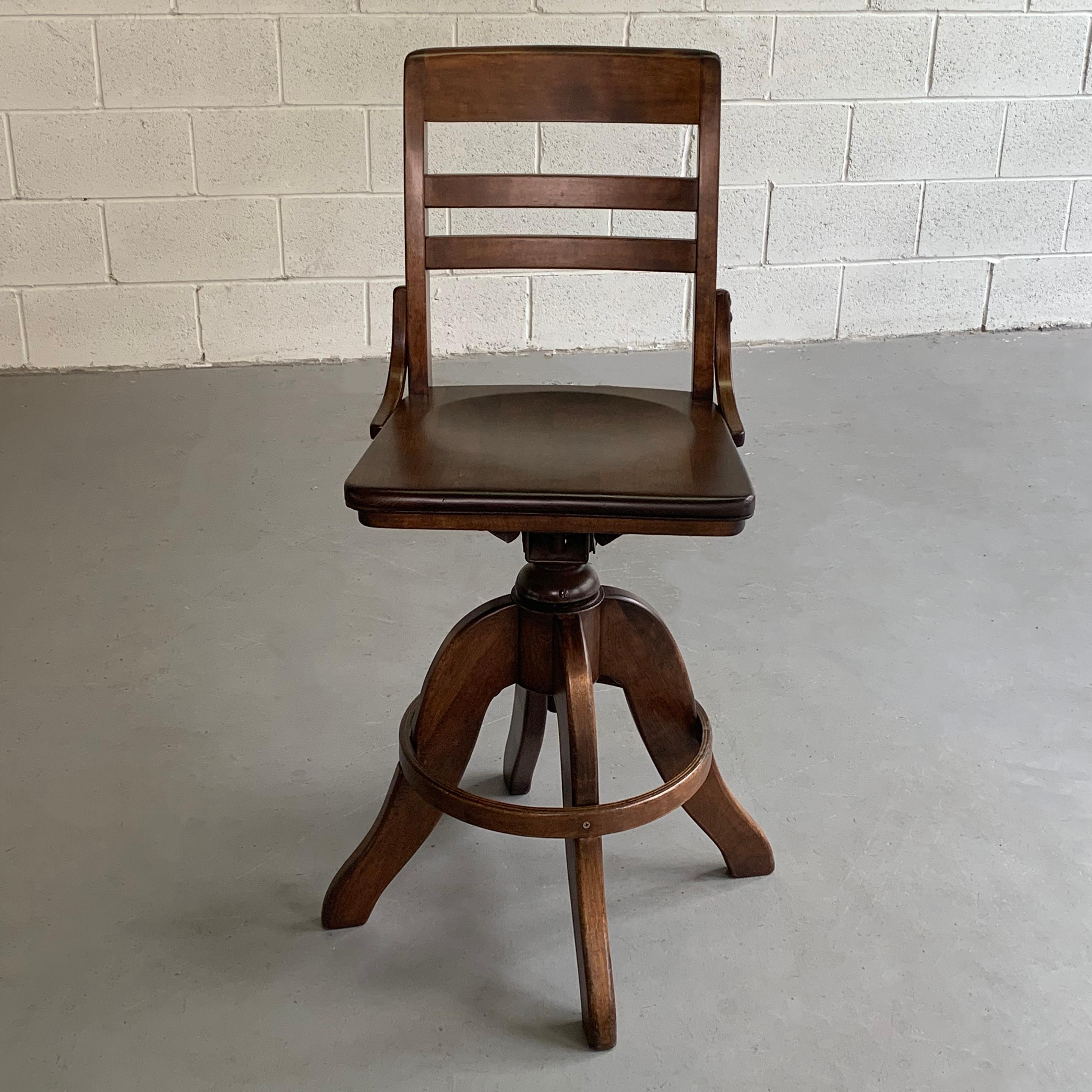 Industrial, stained maple, drafting stool features a swivel seat and height adjustability from 25 - 29 inches.