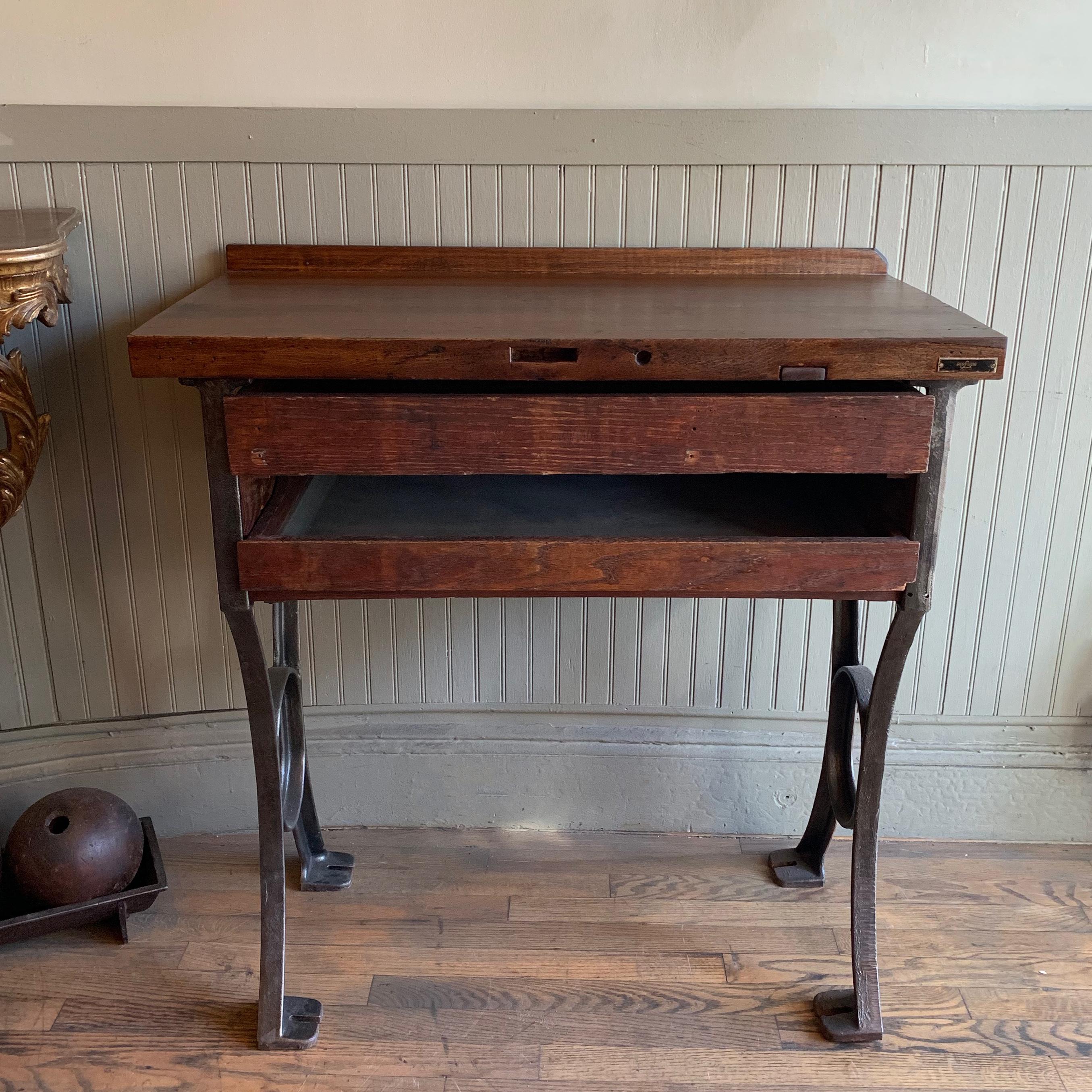 Vintage, 1930s, Industrial, jeweler's bench or work table manufactured by Gesswein, New York features a wonderfully patinated, stained maple top with two pull-out drawers in a cast iron frame.