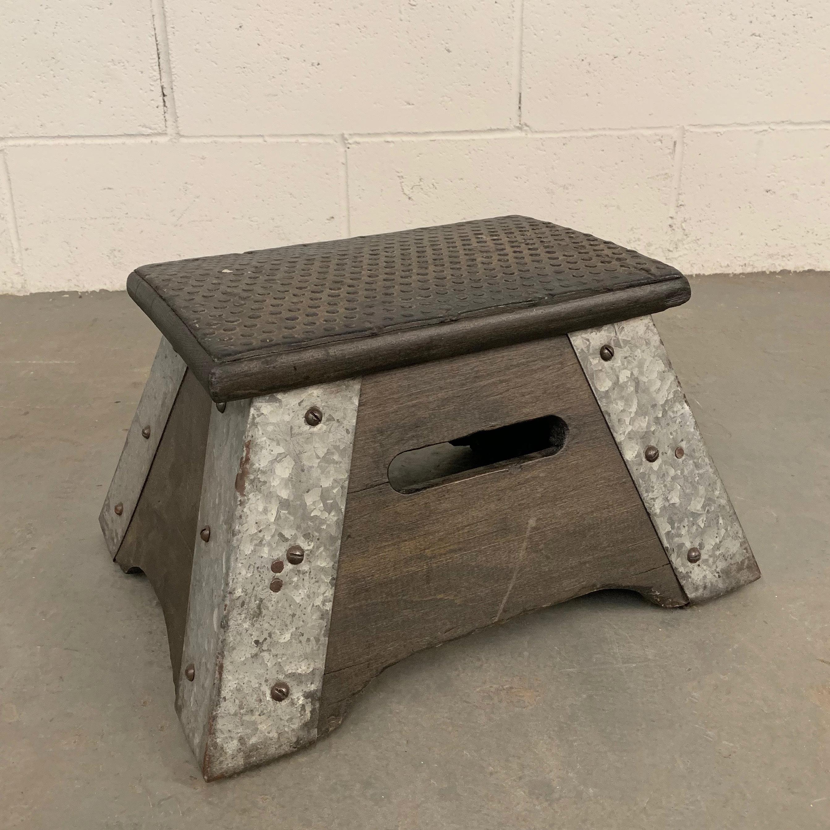 Industrial, train conductor, step stool features an ebonized maple base with galvanized steel edges and rubber grip top that is 12 x 8 inches.