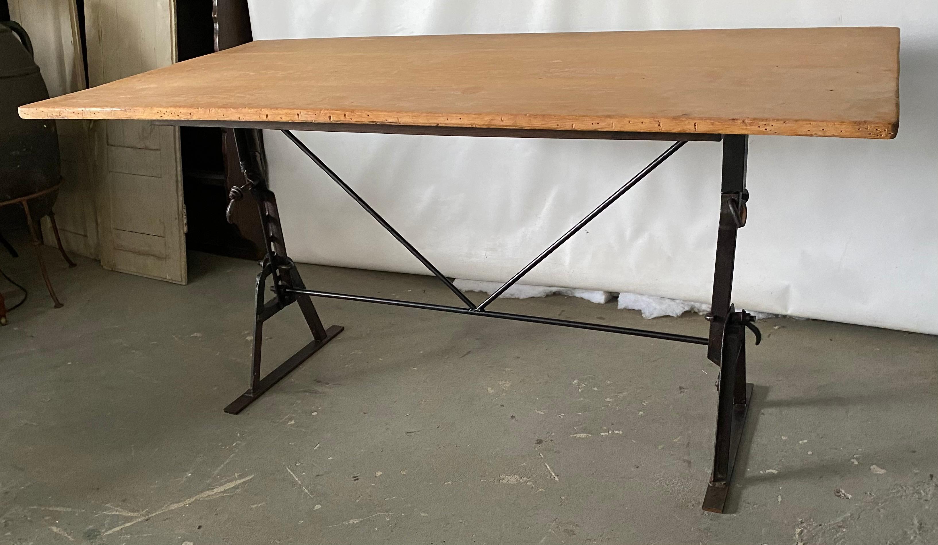 These antique metal workbench saw horses have been adapted and made into a stylish dining table base.  Partnered with a reclaimed teak wood top making it a great desk, office or writing table, a dining table in the kitchen, garden, porch or patio.