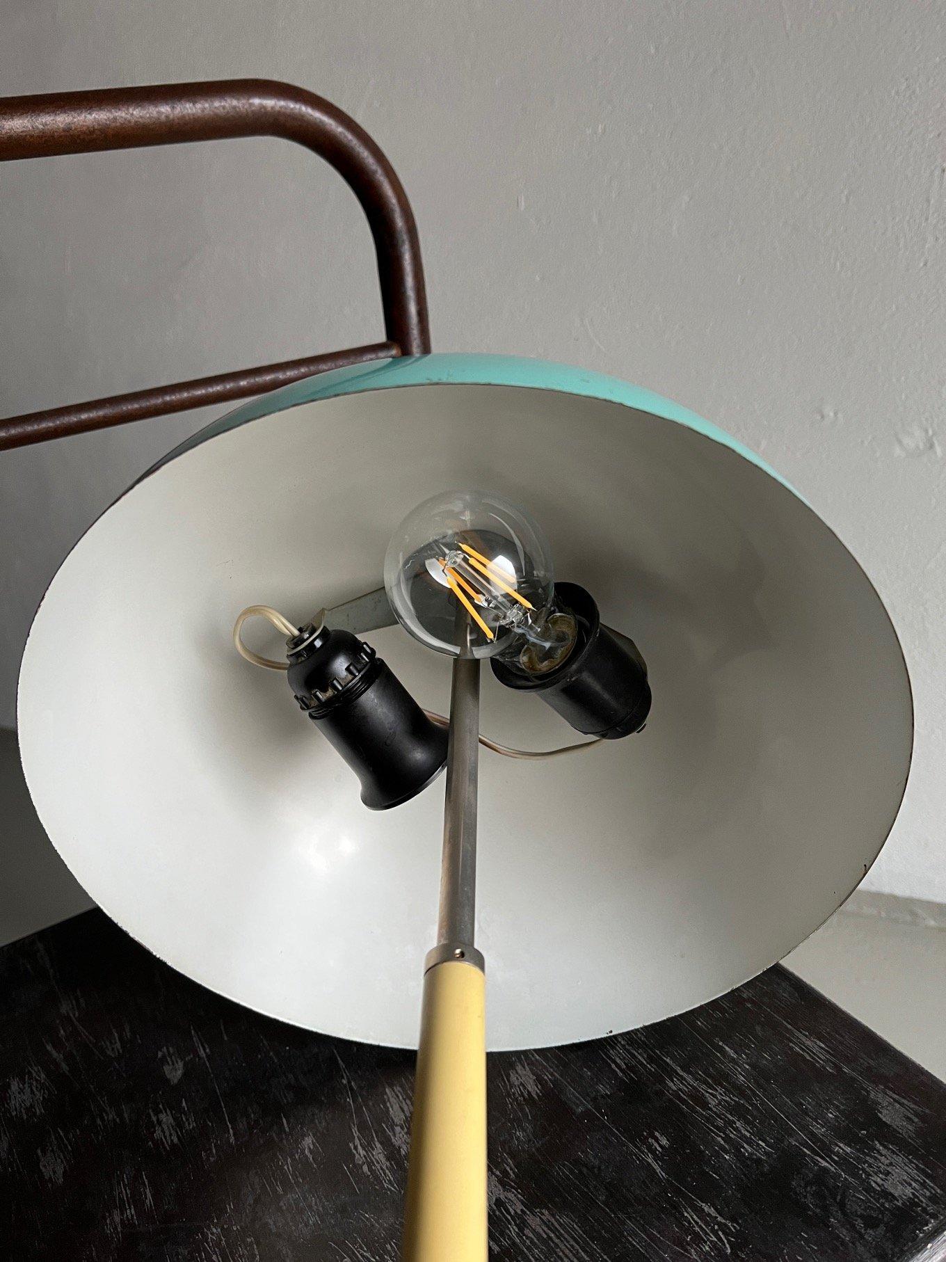 Mint blue painted metal desk lamp with beige plastic handle designed and produced in the USSR. There’s no original button, it has been changed.

Additional information:
Country of manufacture: USSR
Design period: 1970s
Dimensions: 30 D x 46 H