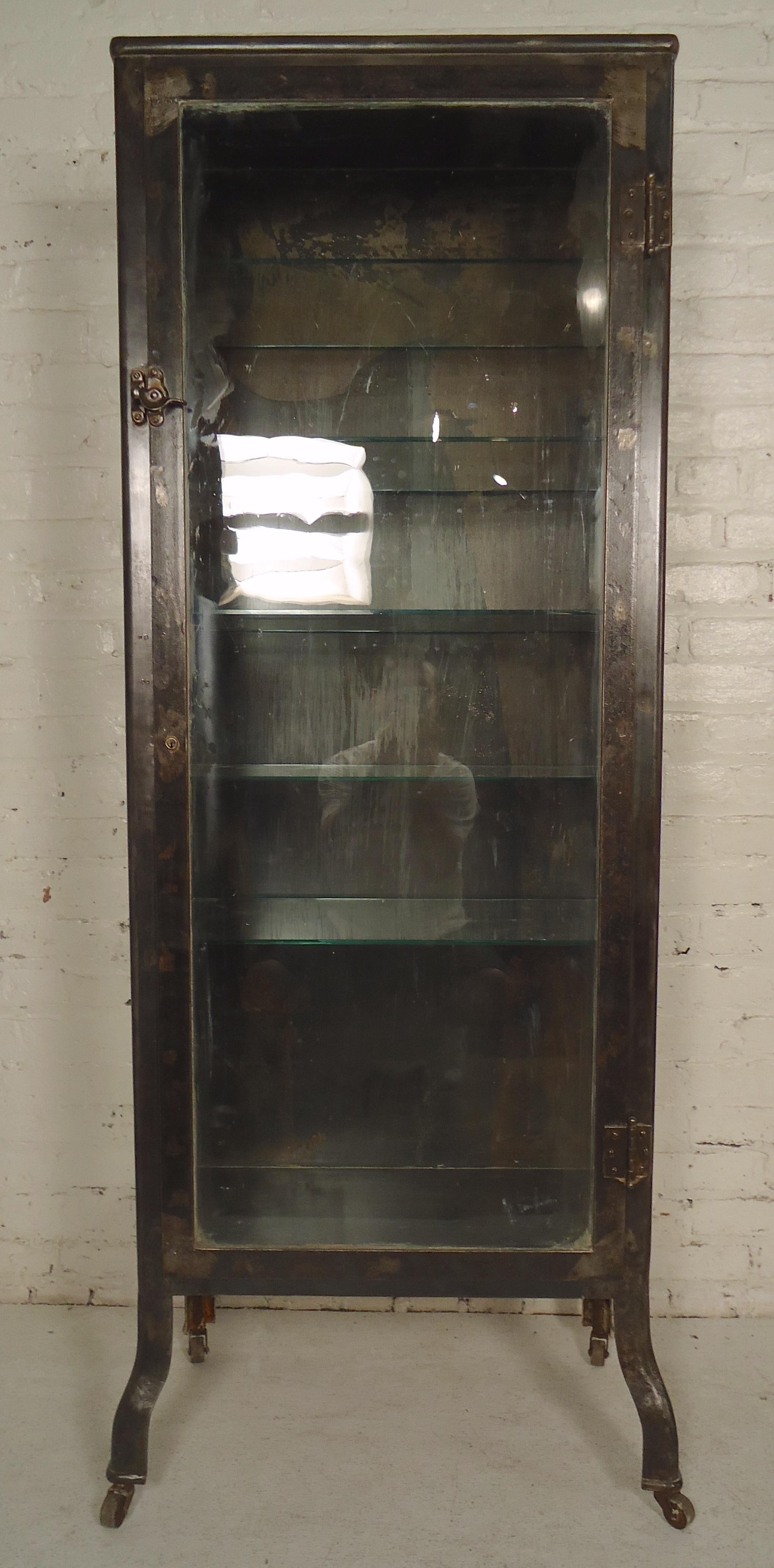 Tall metal cabinet with glass front and sides, newly restored in a bare metal style finish. Includes five glass shelves.

(Please confirm item location - NY or NJ - with dealer).
 