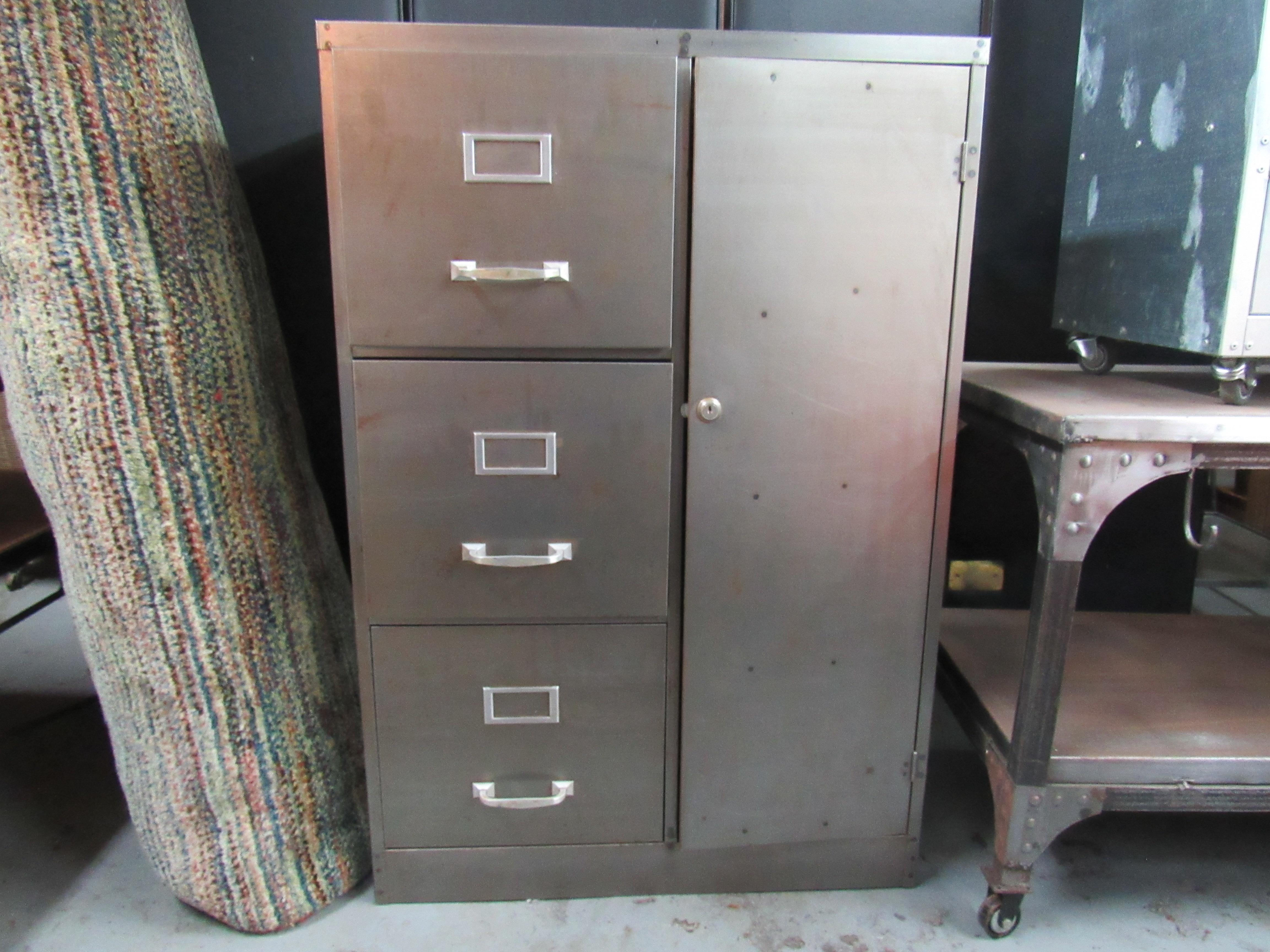 With three large drawers, shelving compartments, and a built-in safe, this vintage industrial cabinet is a great way to add organization to a space with unique style. Please confirm item location with seller (NY/NJ).