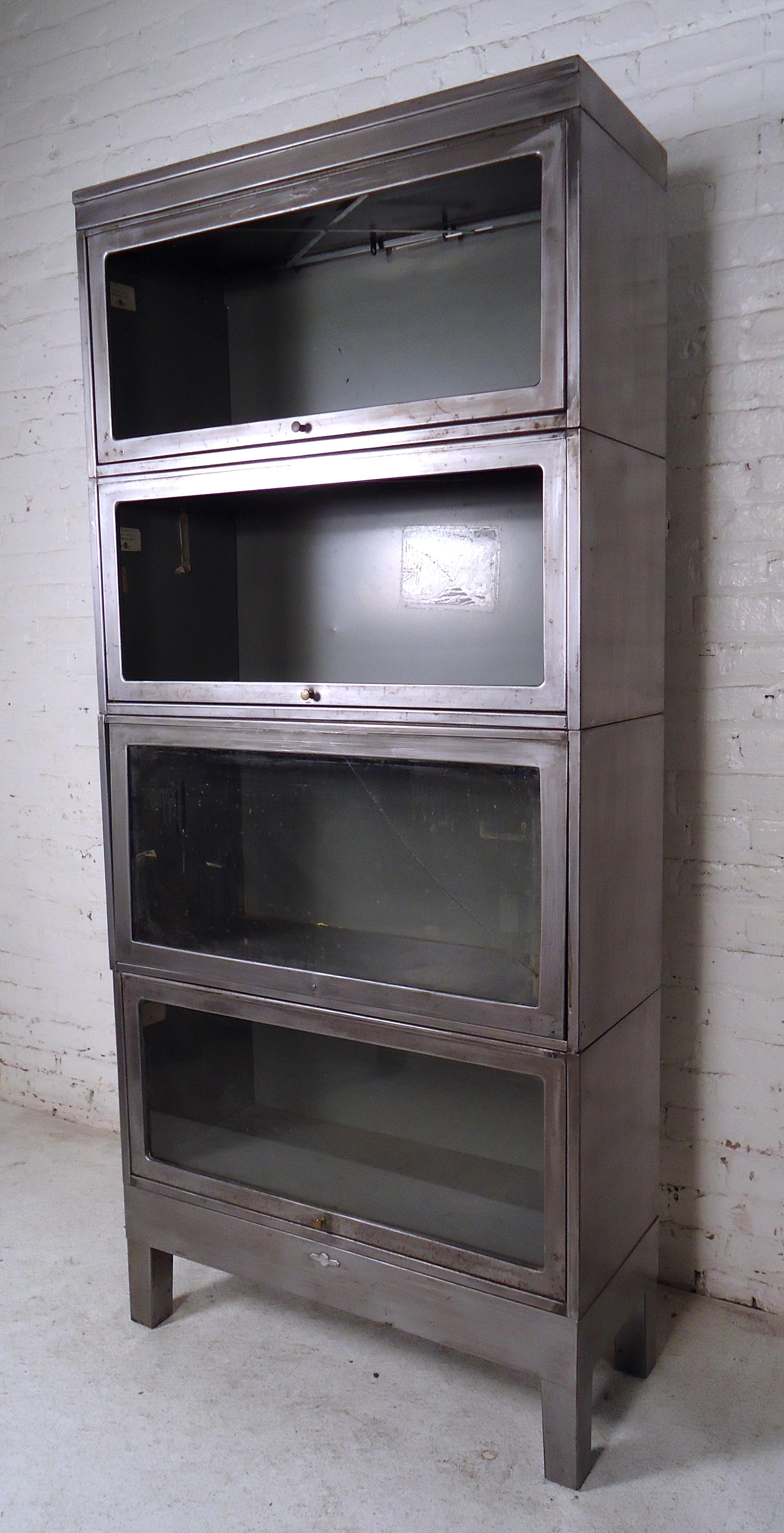 Vintage industrial metal four-stack bookcase features a glass front, round metal knobs and a sturdy metal detachable base. Recessing glass fronts that allow for dust free storage at home or in the office.
(Please confirm item location-NY or NJ,