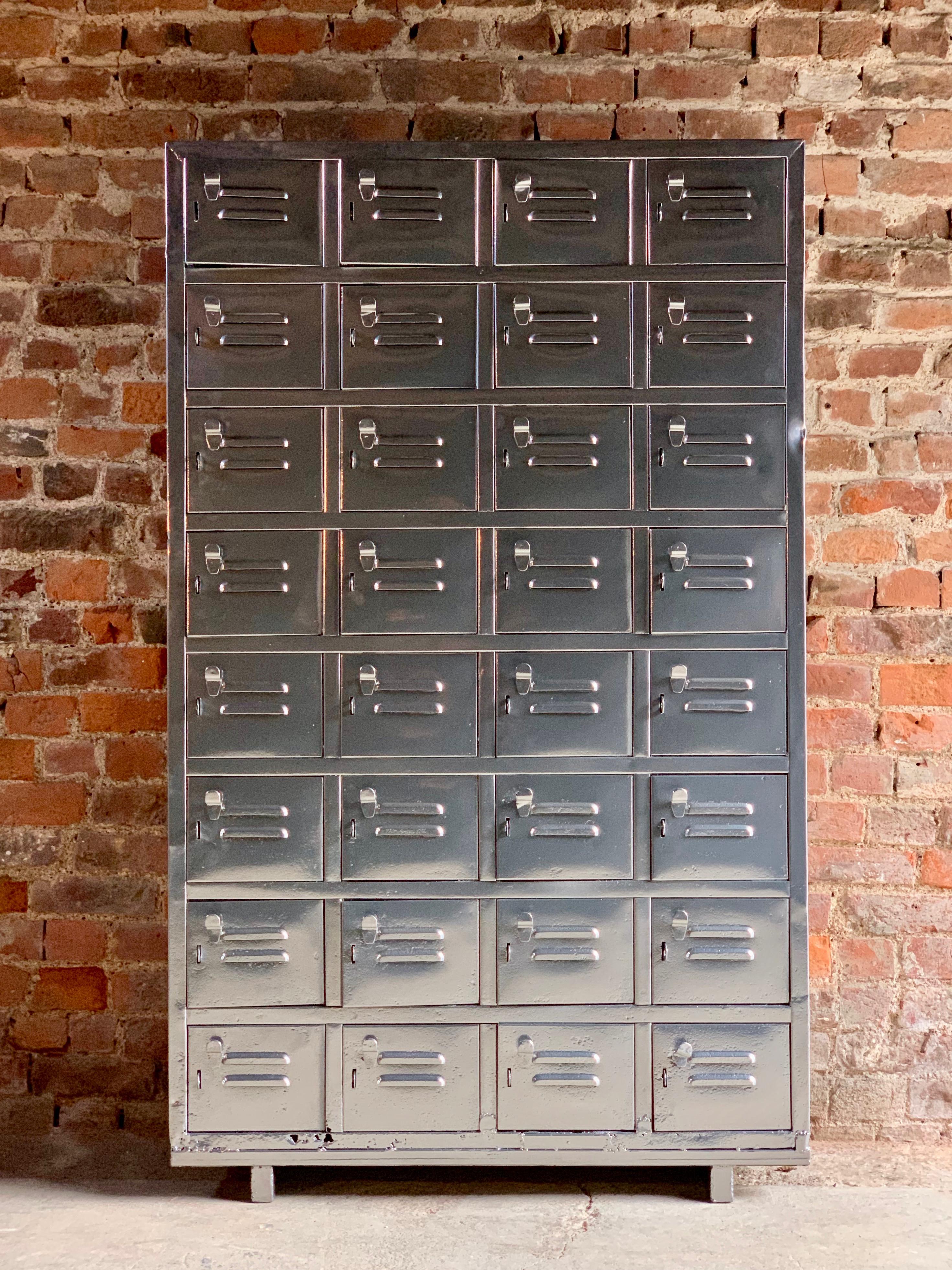 A stunning set of Industrial metal lockers dating to circa 1940s, recently sand blasted and powder coated, having a total of thirty two vented lockers with pull handles with brackets for padlocks, standing on four block feet.

Condition: Age