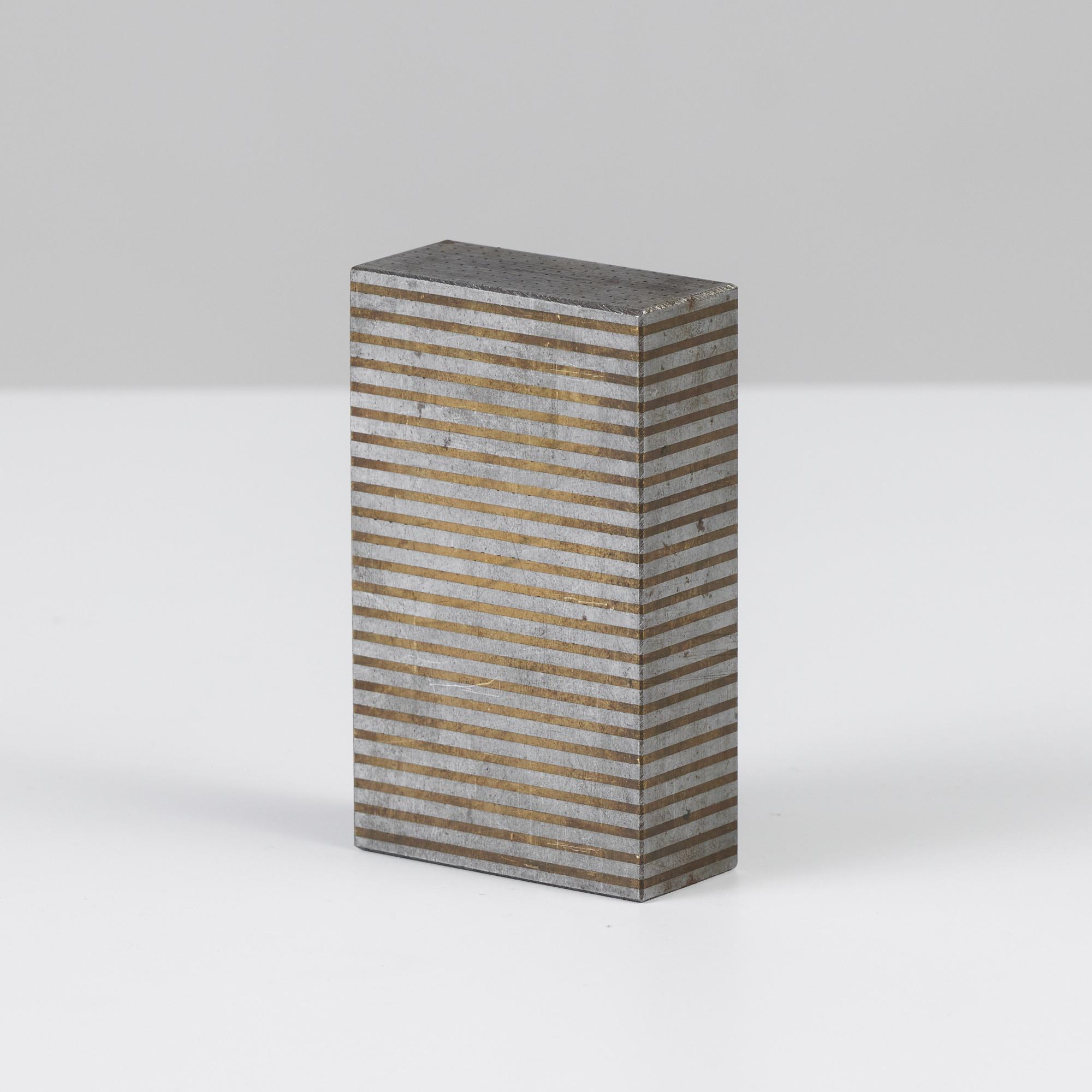 Industrial machine block featuring alternating patinated bronze and silver striations with pin hole detail on the top and bottom.

 mb009

Dimensions: 2.5